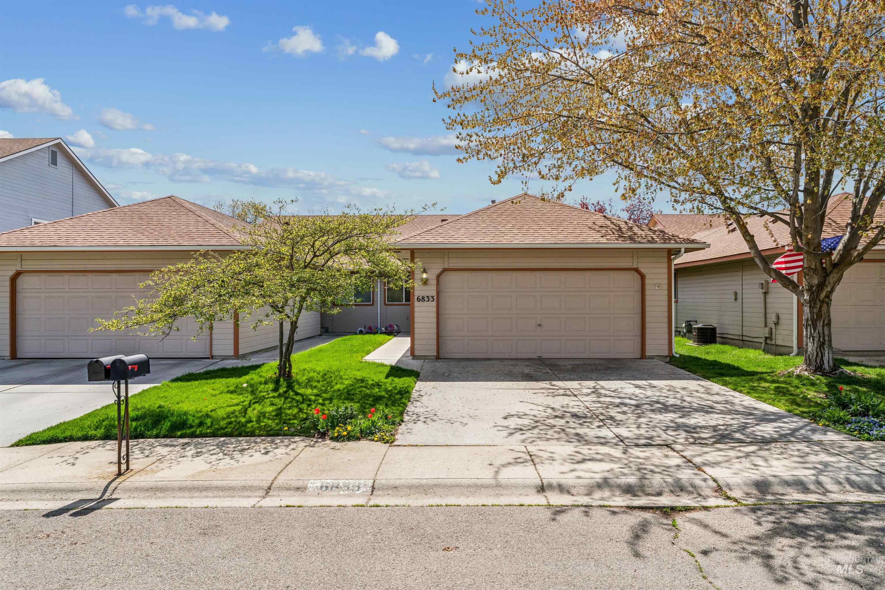 Single story home featuring roof with shingles, a front lawn, and driveway
