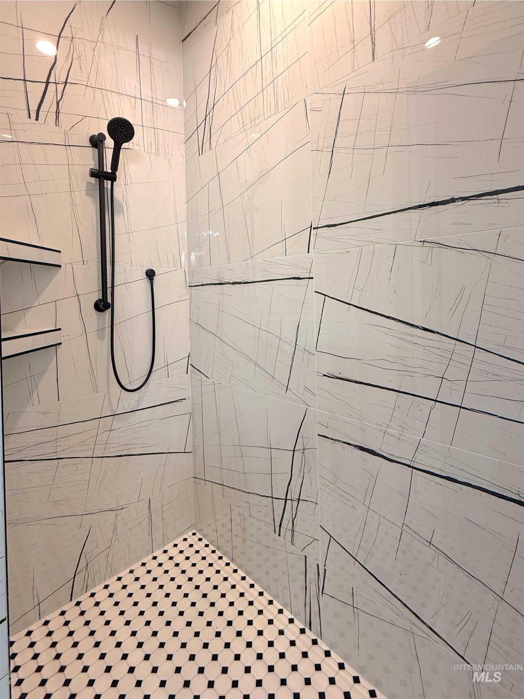 Full bath featuring a tile shower