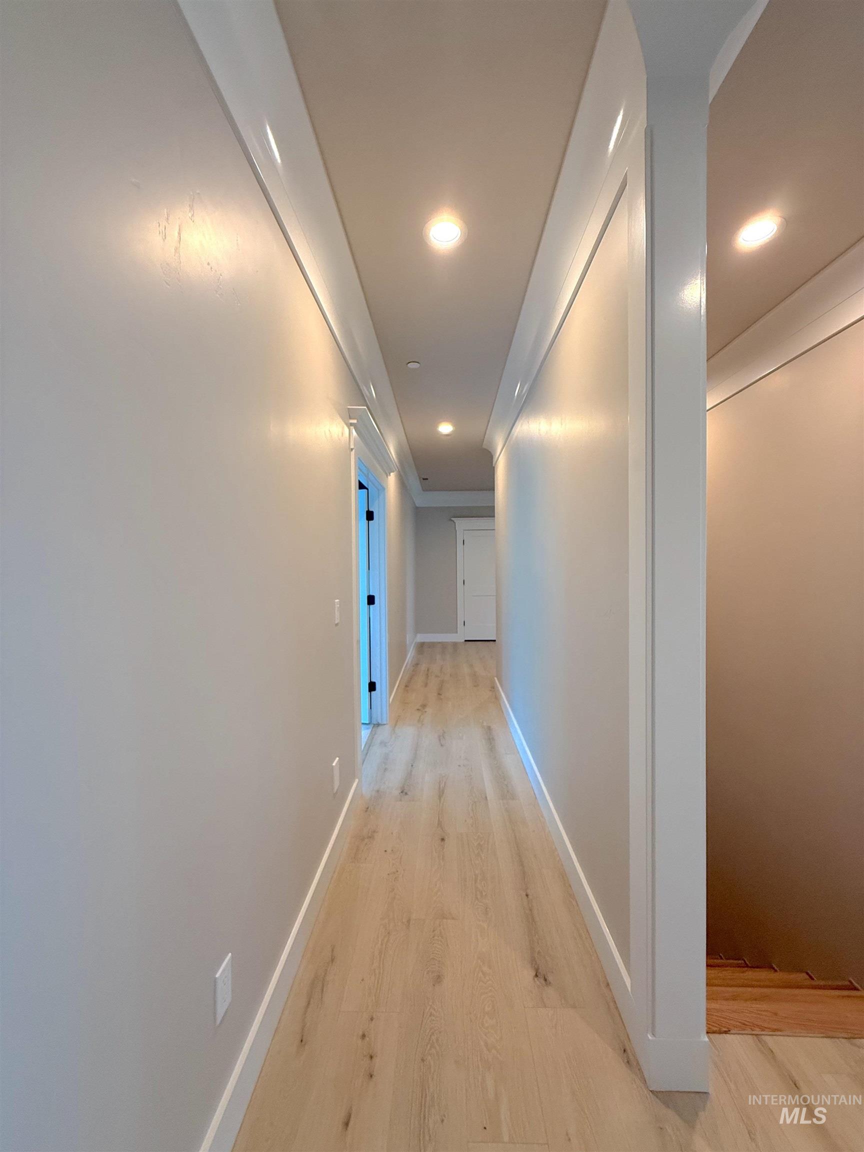 Hall featuring light wood-style floors and recessed lighting