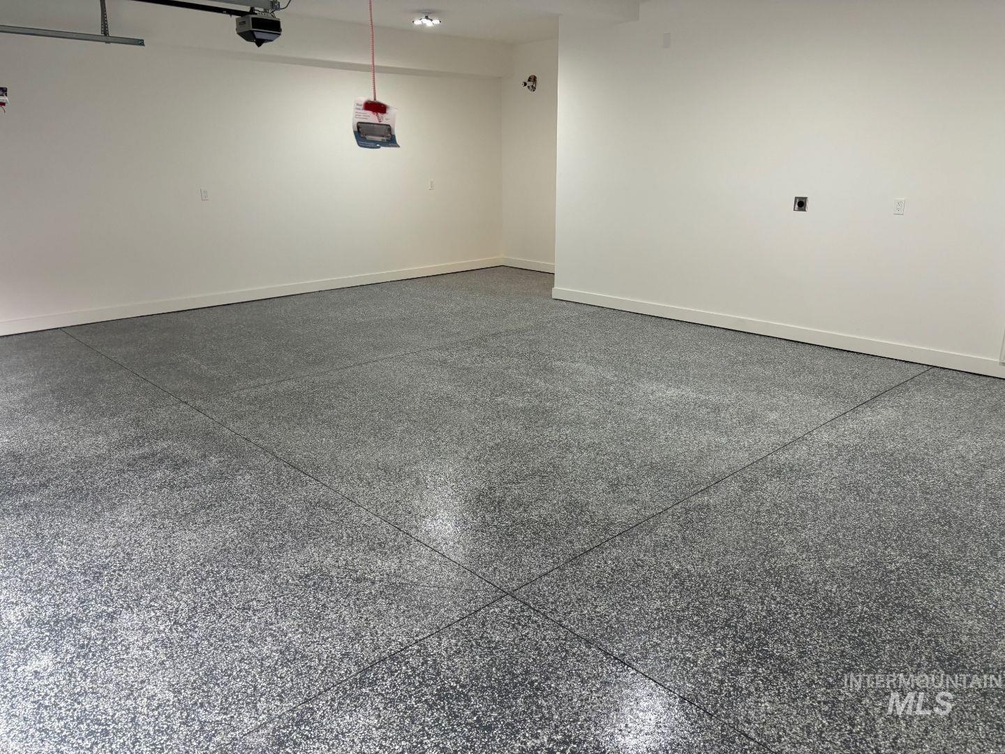 Garage featuring baseboards