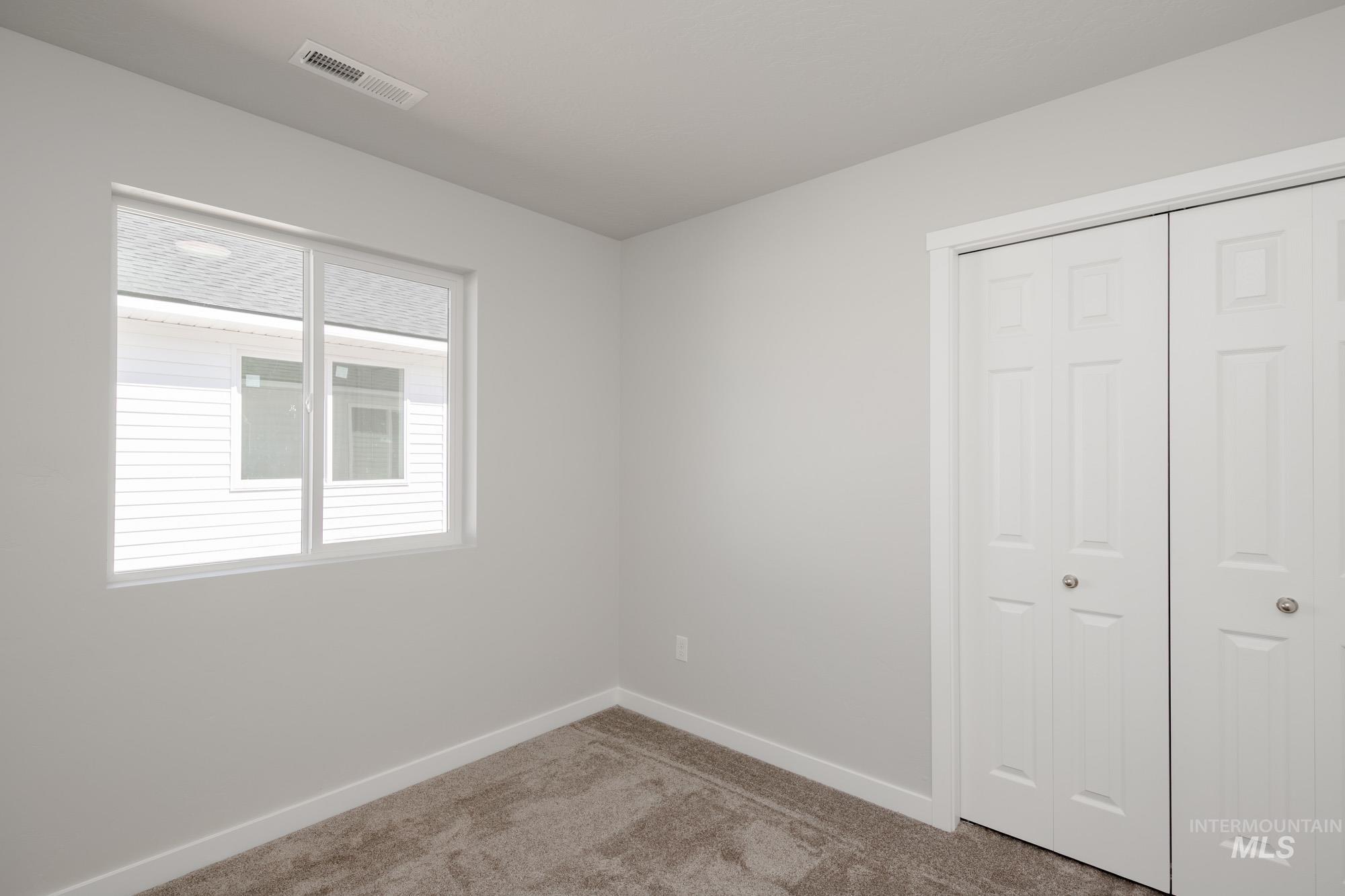Unfurnished bedroom featuring carpet floors and a closet