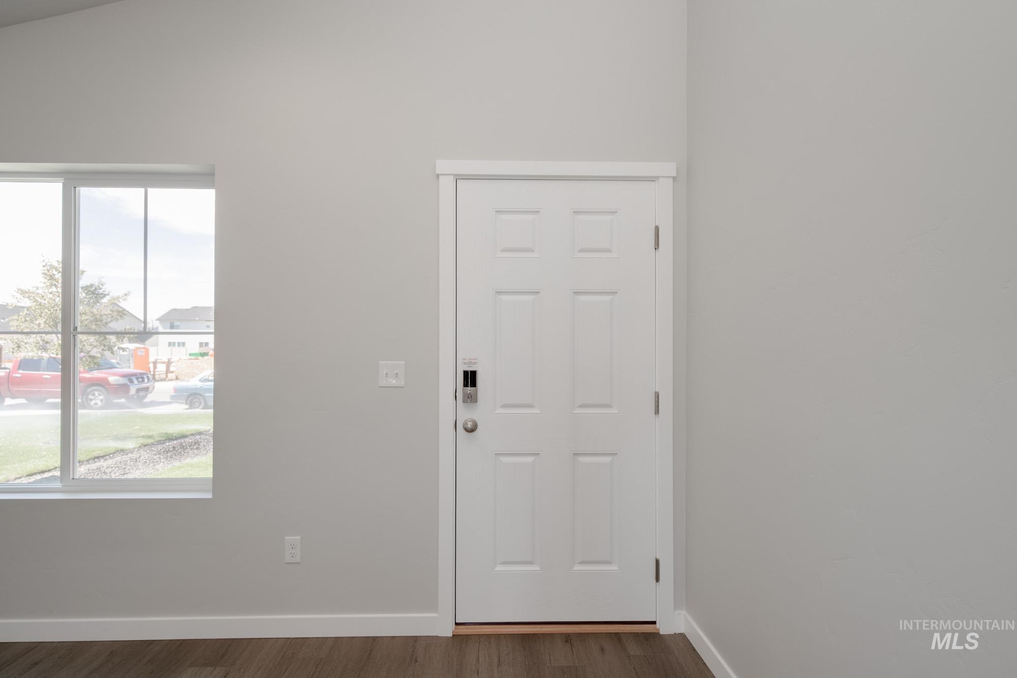 Entryway with baseboards and dark wood-style floors