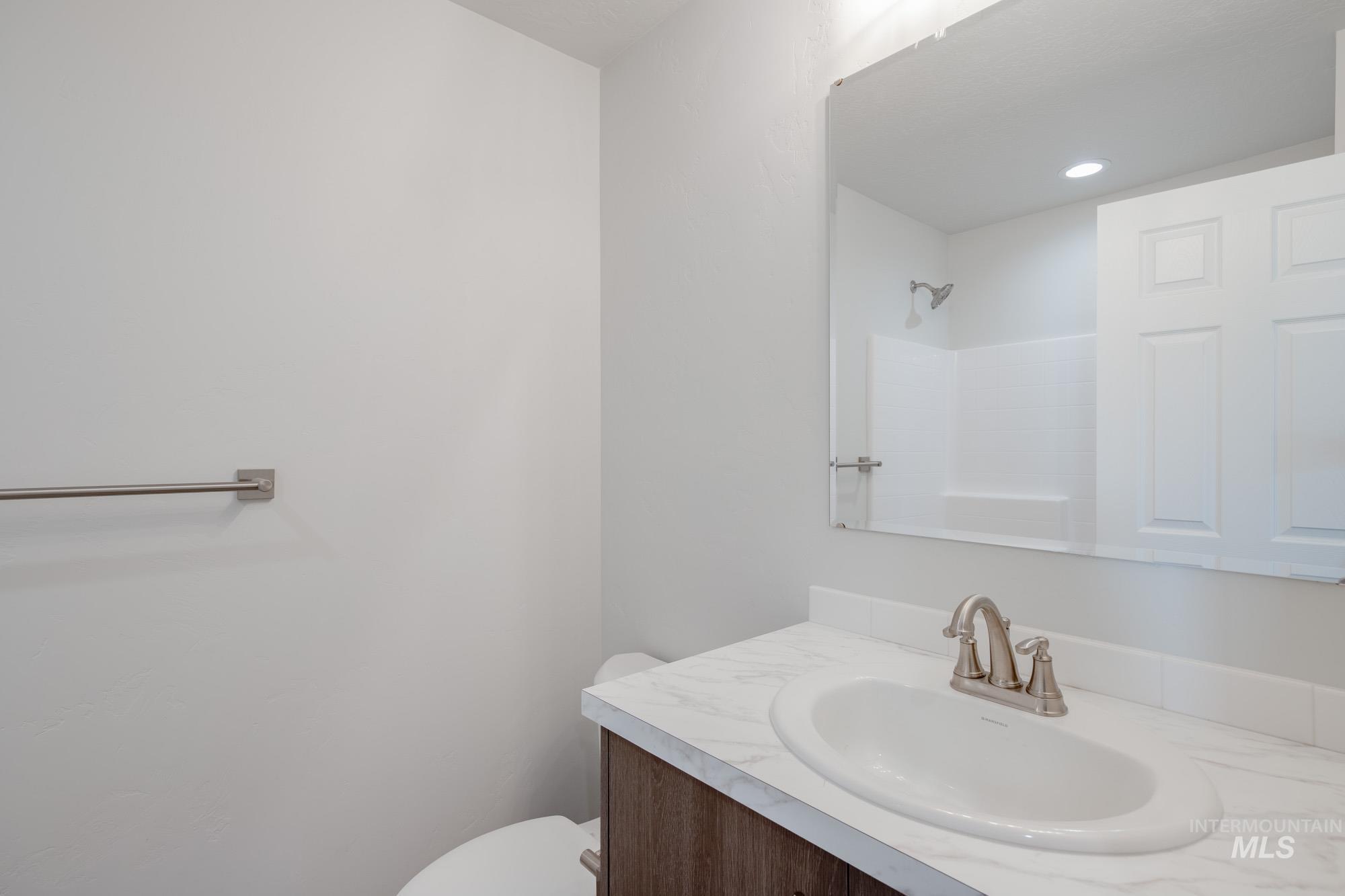 Bathroom with vanity and a shower