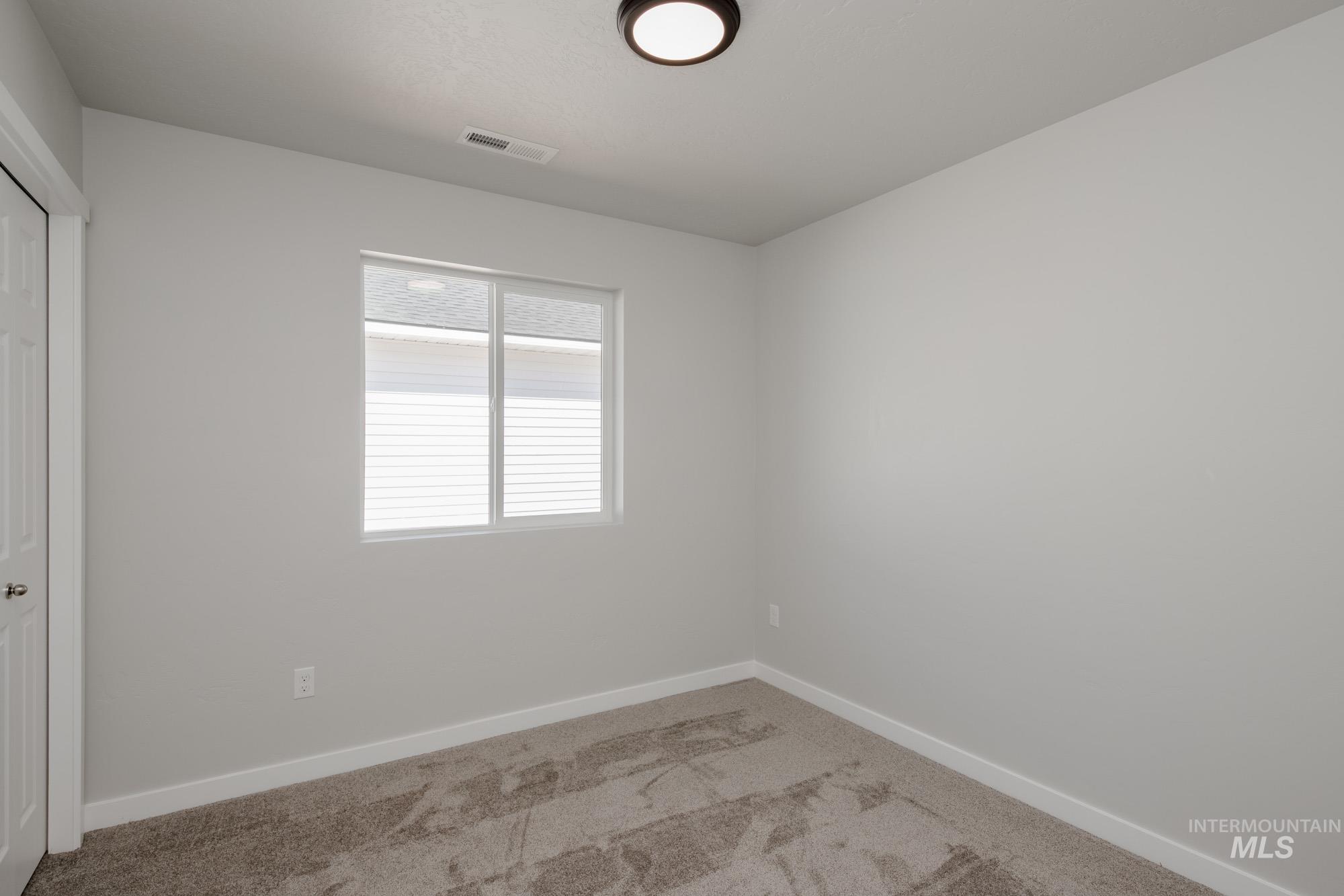 Unfurnished room featuring carpet floors and baseboards