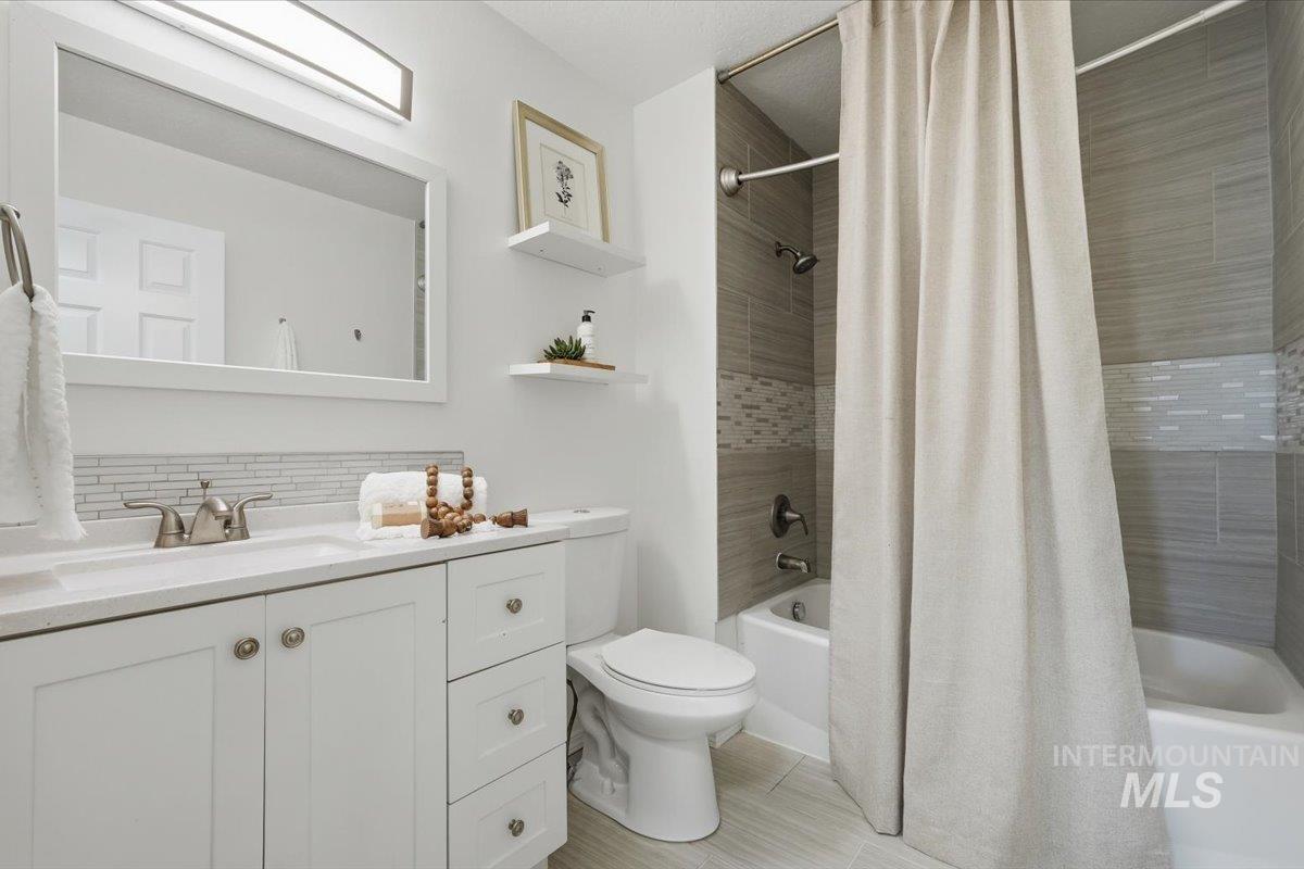 White vanity with brushed nickel hardware, integrated sink, and white framed mirror