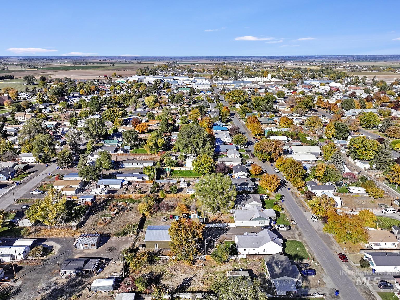 Aerial view of property and surrounding area with nearby suburban area