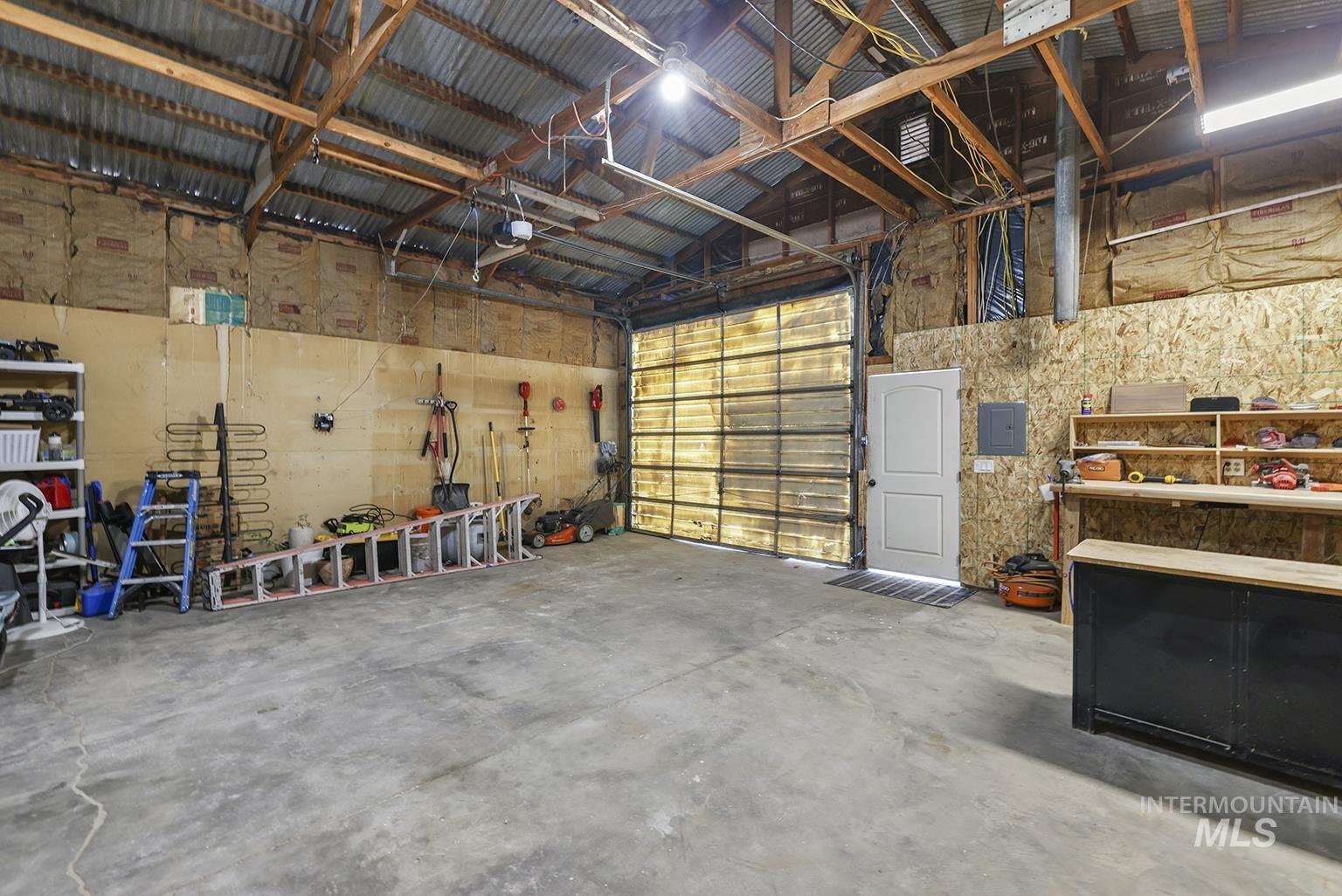 Garage with electric panel and a garage door opener