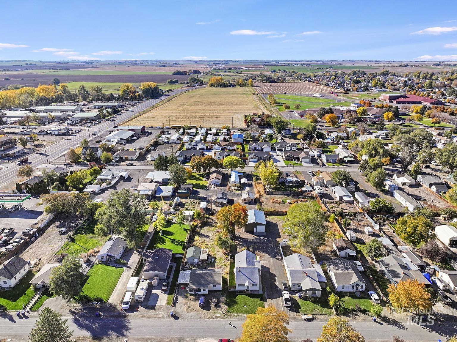 Aerial view of property and surrounding area with nearby suburban area and rural landscape
