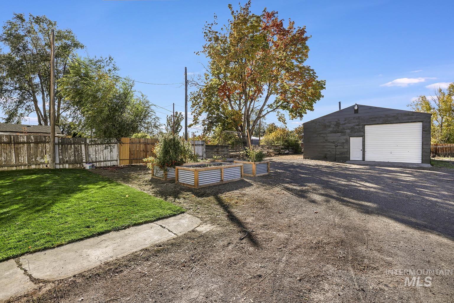 View of yard with a vegetable garden, an outbuilding, and a detached garage