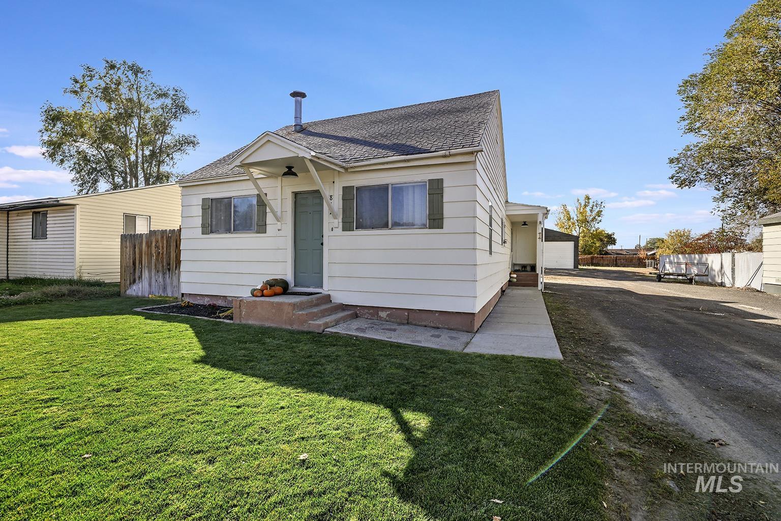 Back of property featuring roof with shingles