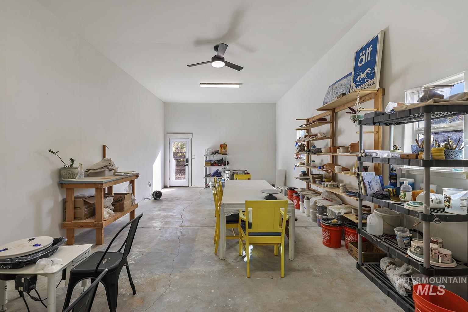 Miscellaneous room featuring concrete flooring and a ceiling fan
