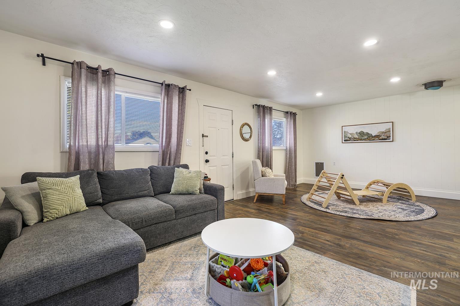 Living area with recessed lighting, plenty of natural light, and wood finished floors
