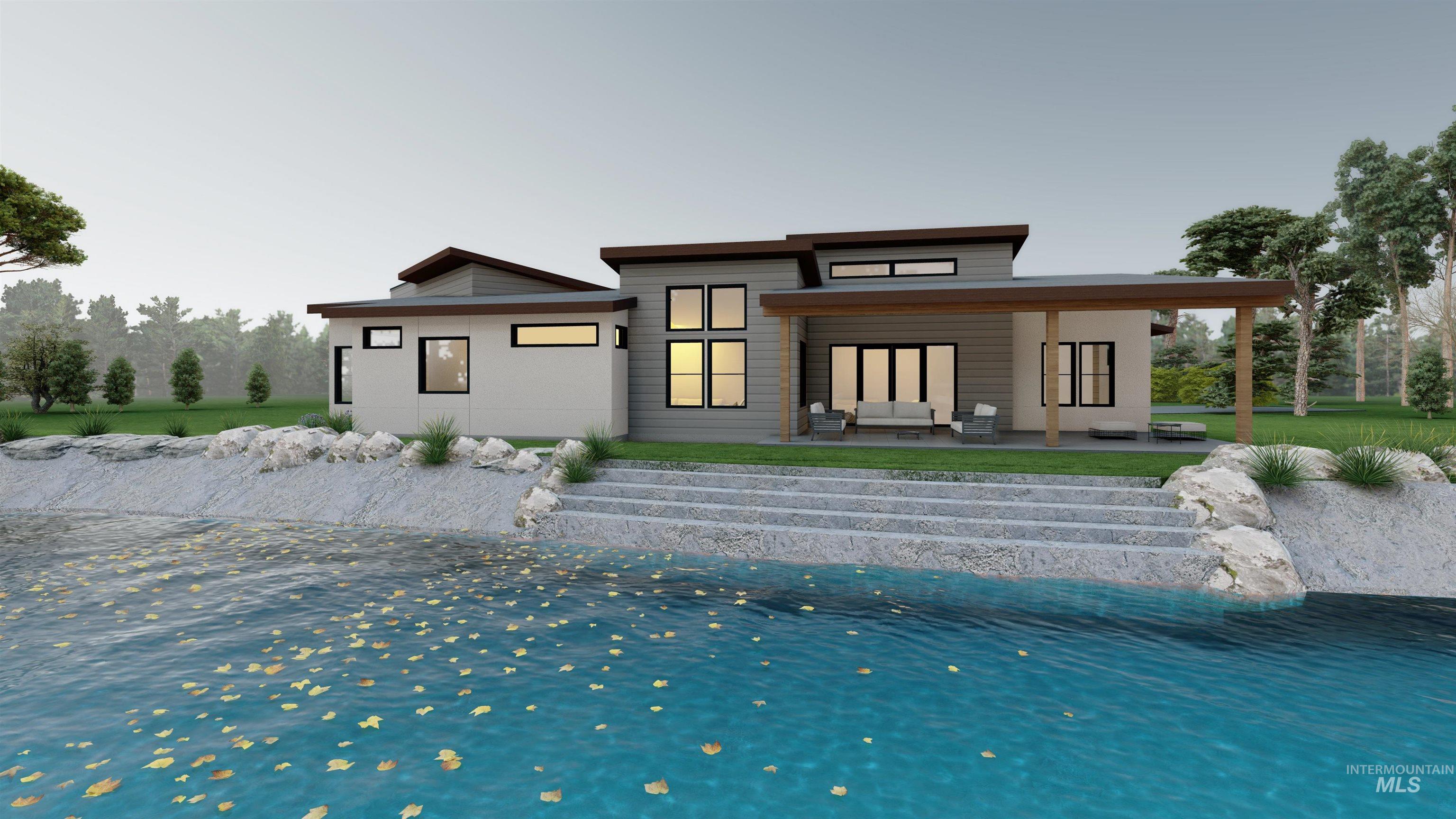 Rear view of property with a patio area, sandy beach and boulders