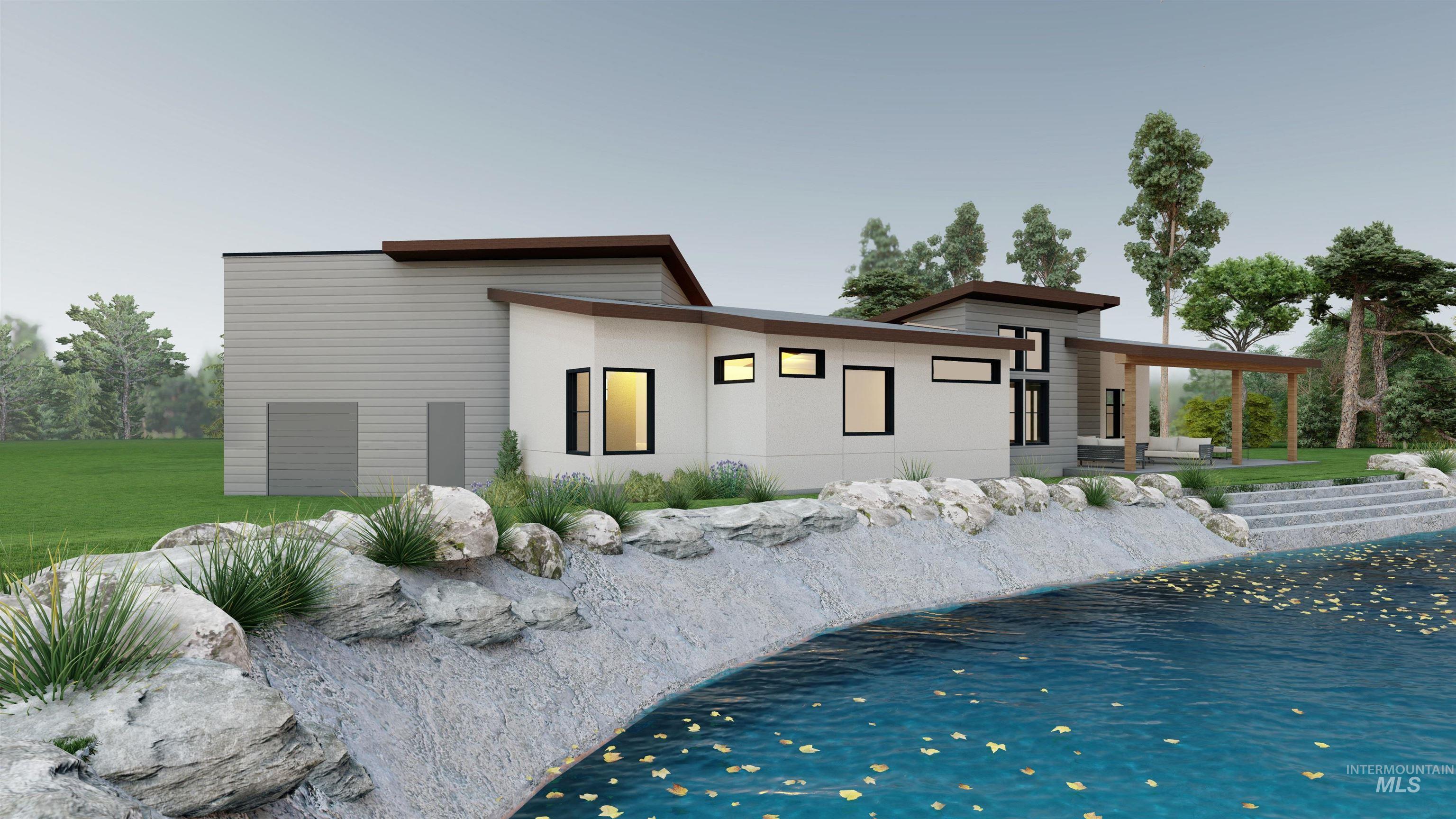 Back of property featuring a water view, sandy beach, lawn