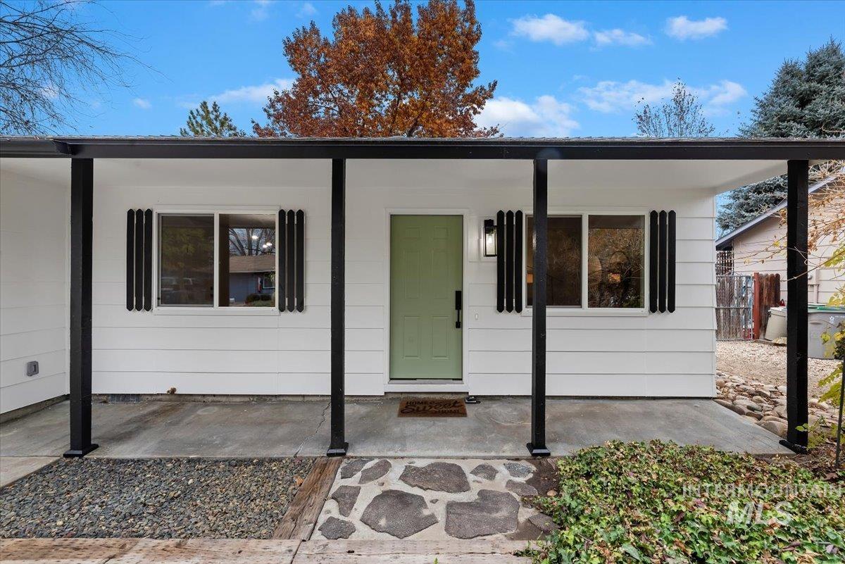 Doorway to property featuring covered porch