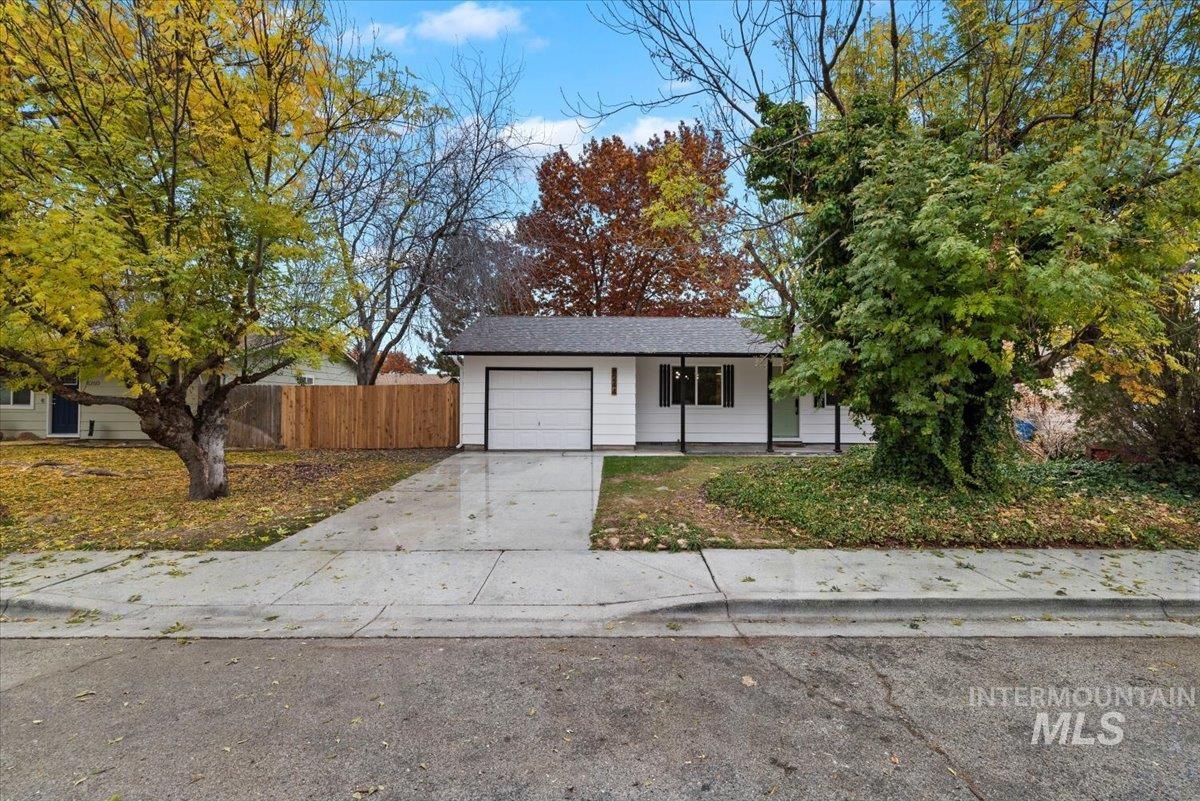 Ranch-style home featuring driveway and an attached garage