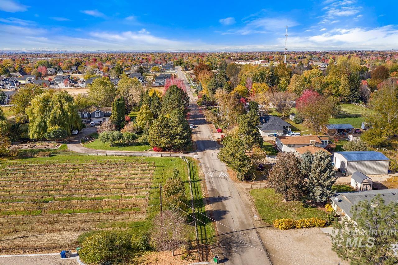 Expansive aerial showing a vineyard property with surrounding residential areas