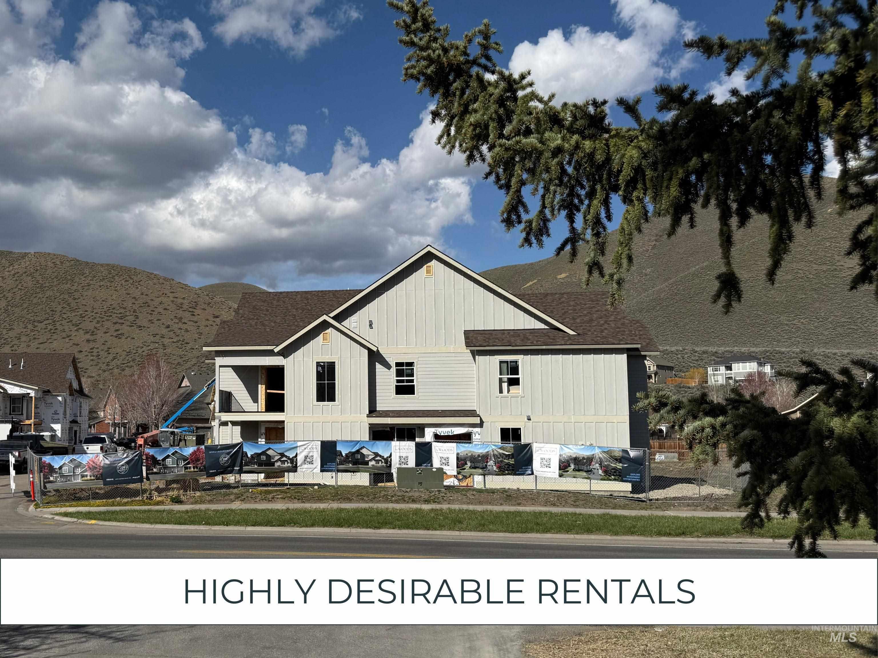 View of front of house featuring a mountain view, roof with shingles, and board and batten siding