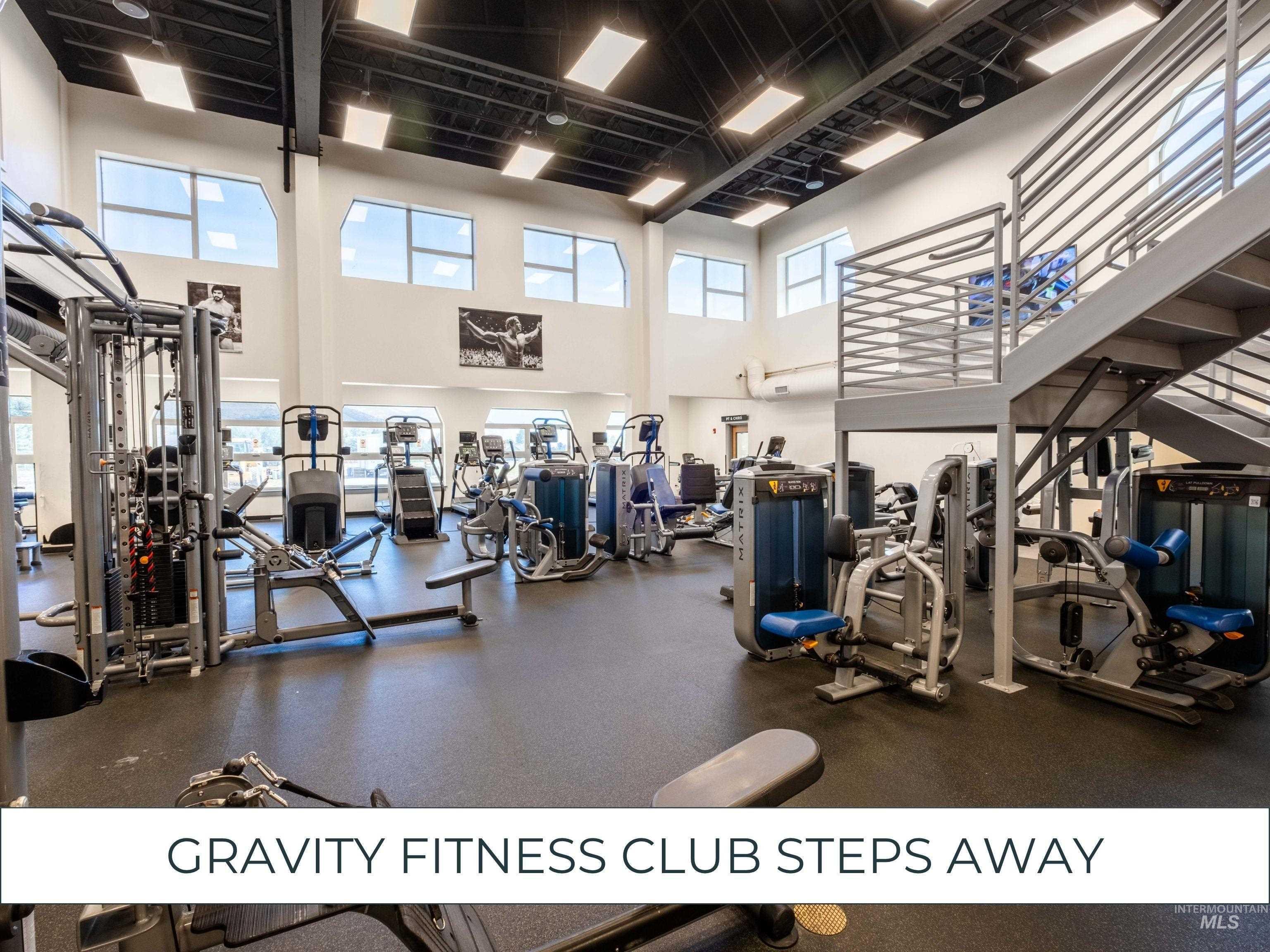 Exercise room featuring plenty of natural light and a high ceiling