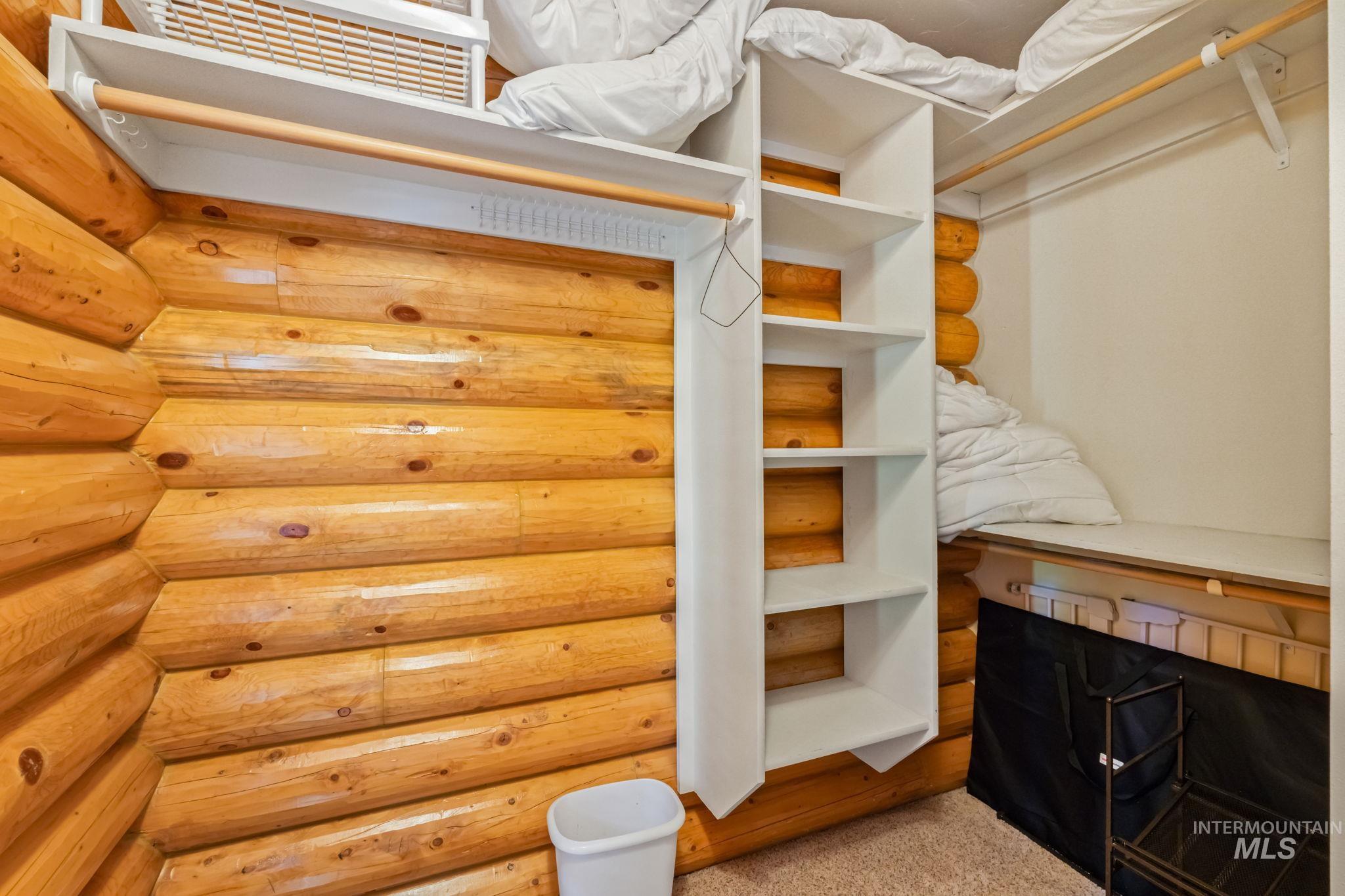 Spacious closet with light colored carpet
