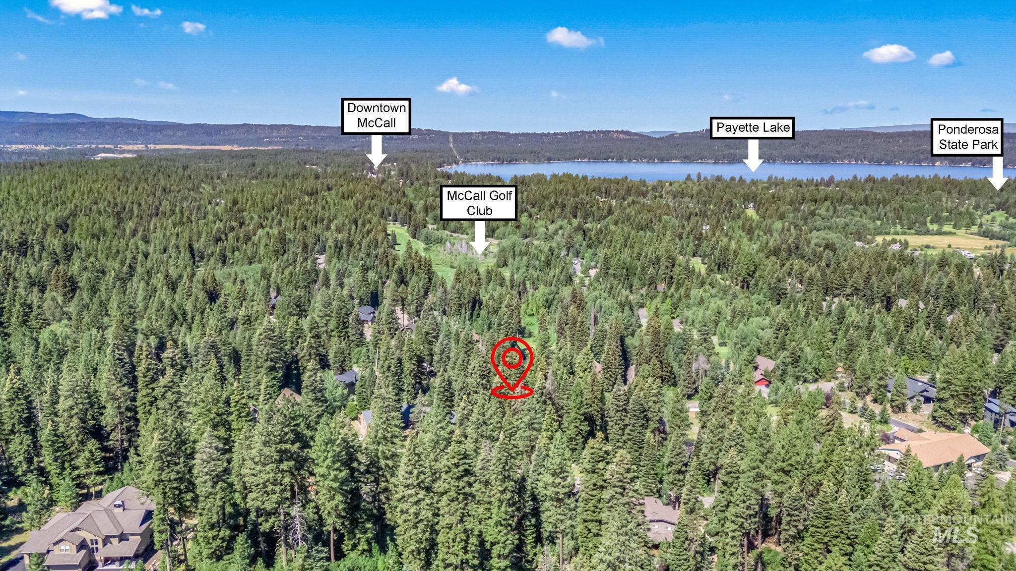 View of property location featuring a forest