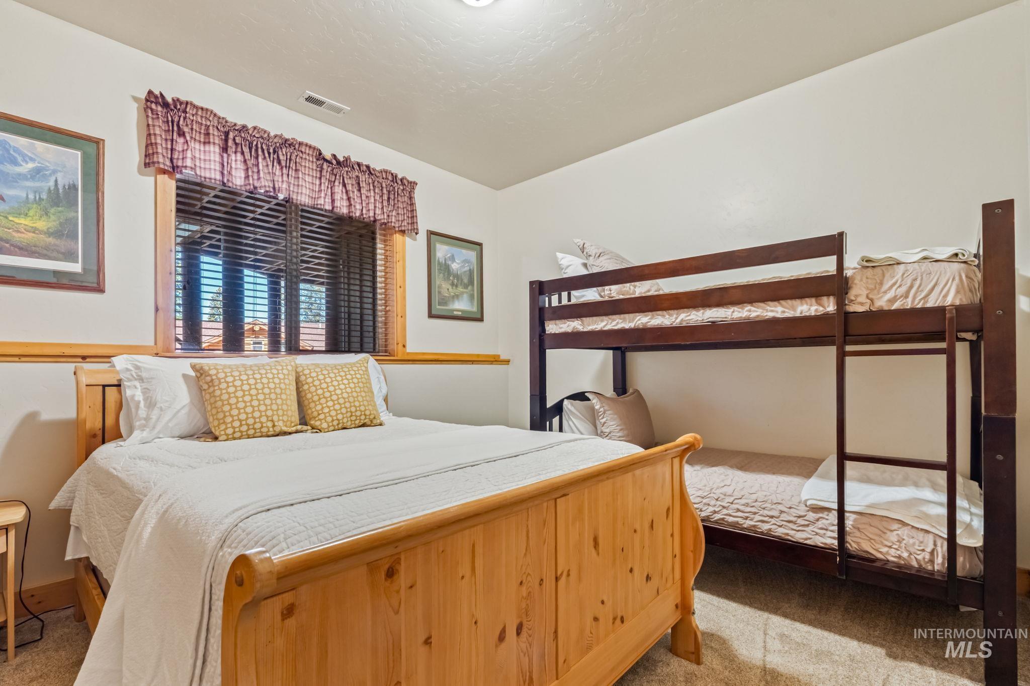 Bedroom with light carpet