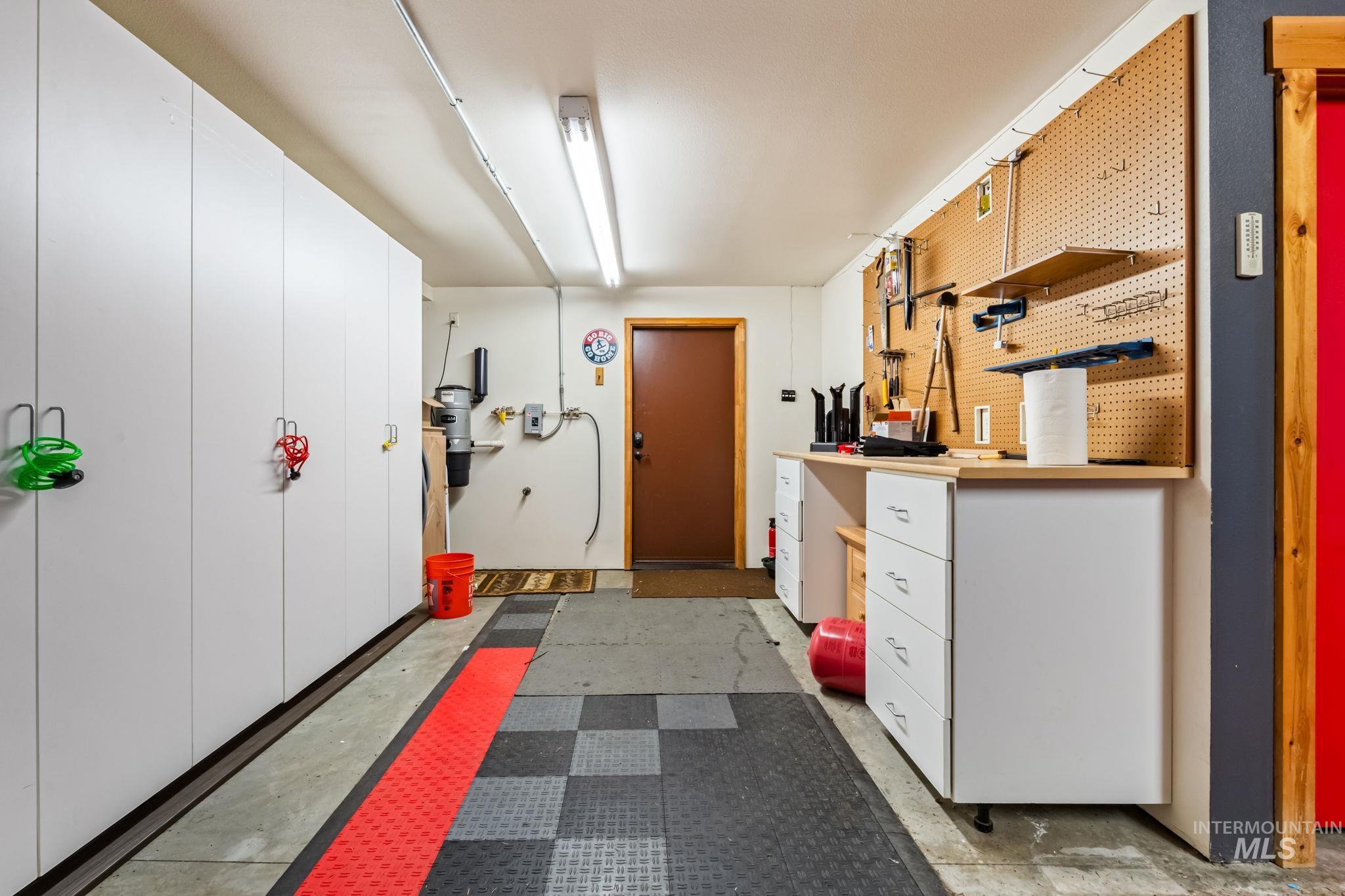 Kitchen with white cabinets, open shelves, and light flooring