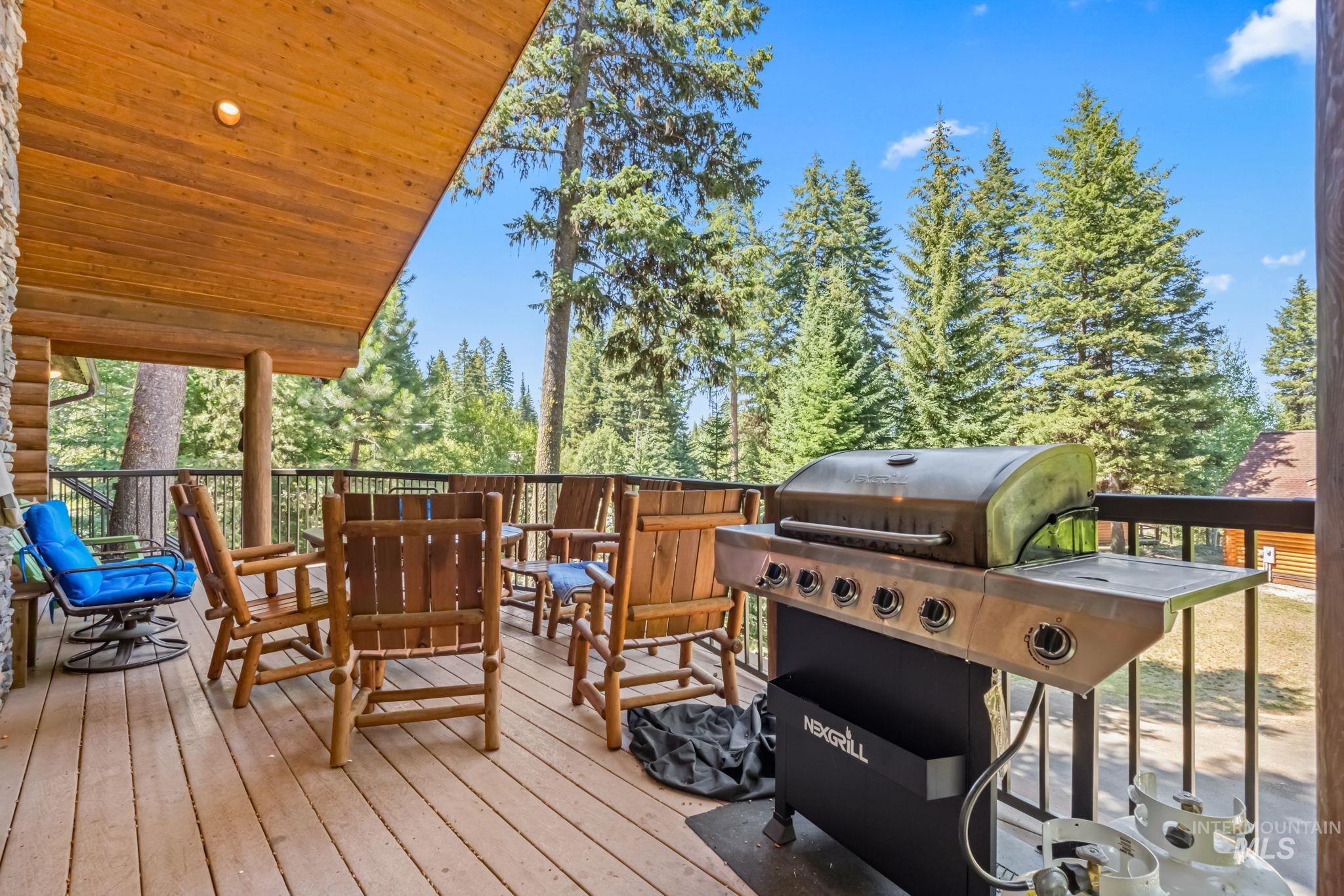 Wooden terrace featuring grilling area