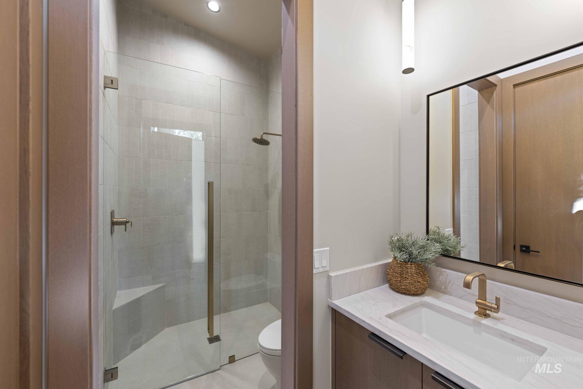 Full bathroom featuring vanity, a stall shower, and recessed lighting