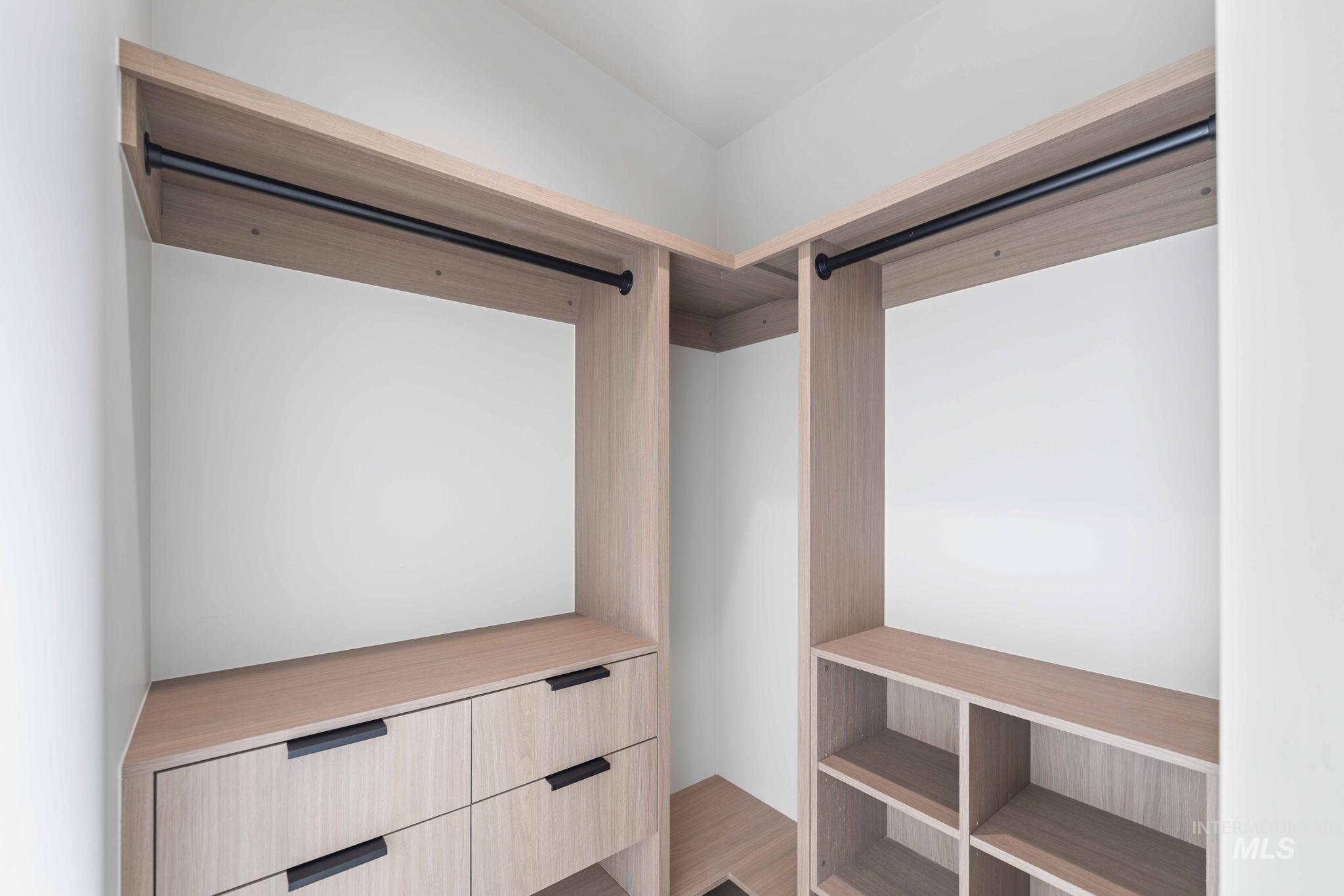 Walk in closet with wood finished floors