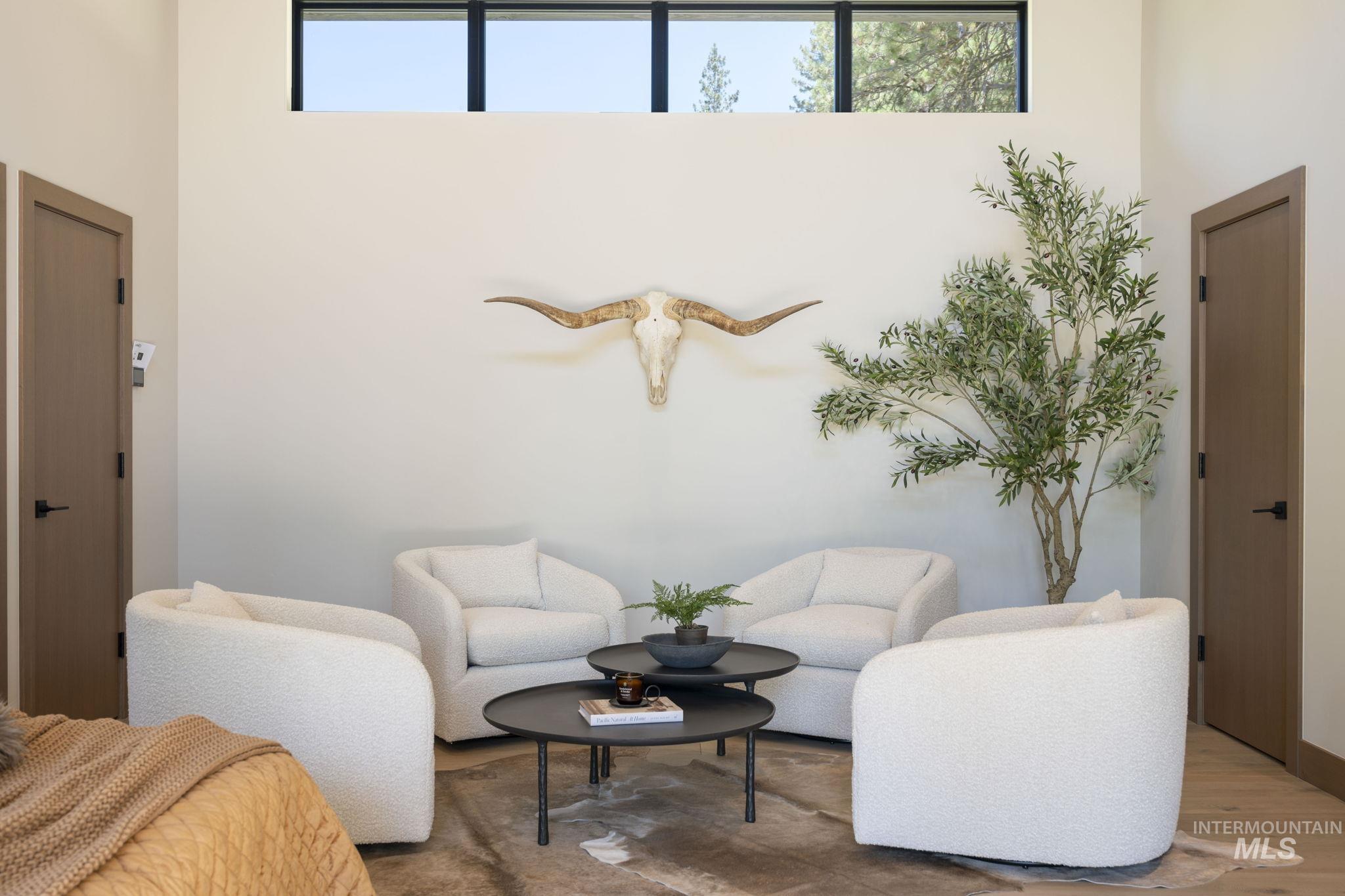 Sitting room featuring plenty of natural light and wood finished floors