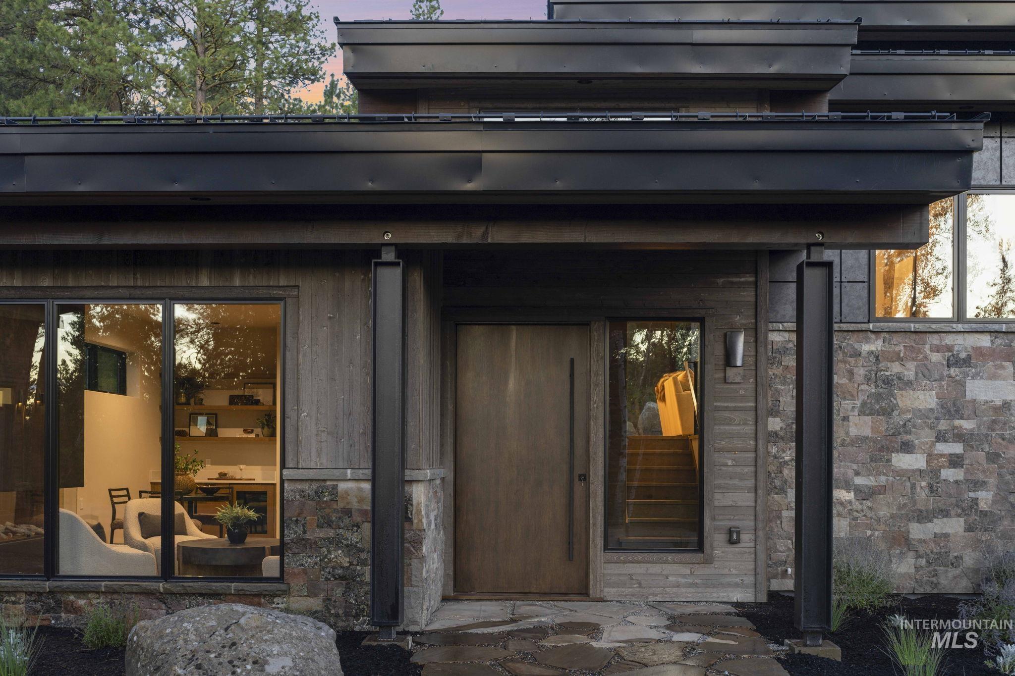 Doorway to property with stone siding