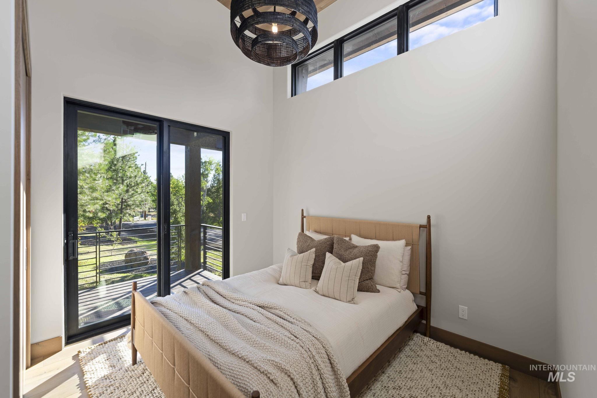 Bedroom featuring access to outside and wood finished floors