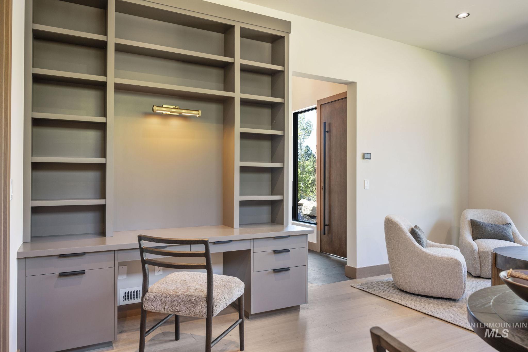 Office area with light wood finished floors and recessed lighting