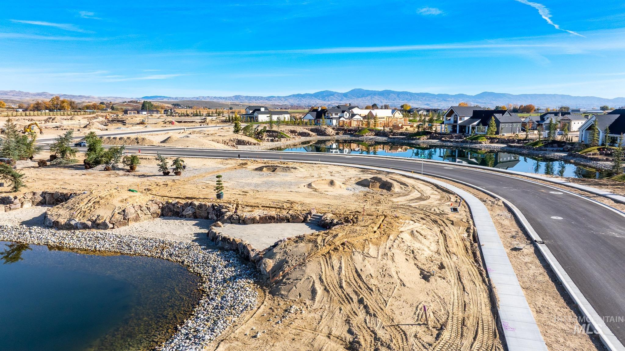 Aerial perspective of suburban area with a water and mountain view