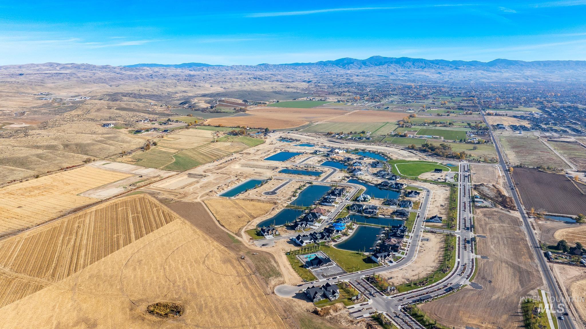 Aerial overview of property's location featuring a water and mountain view