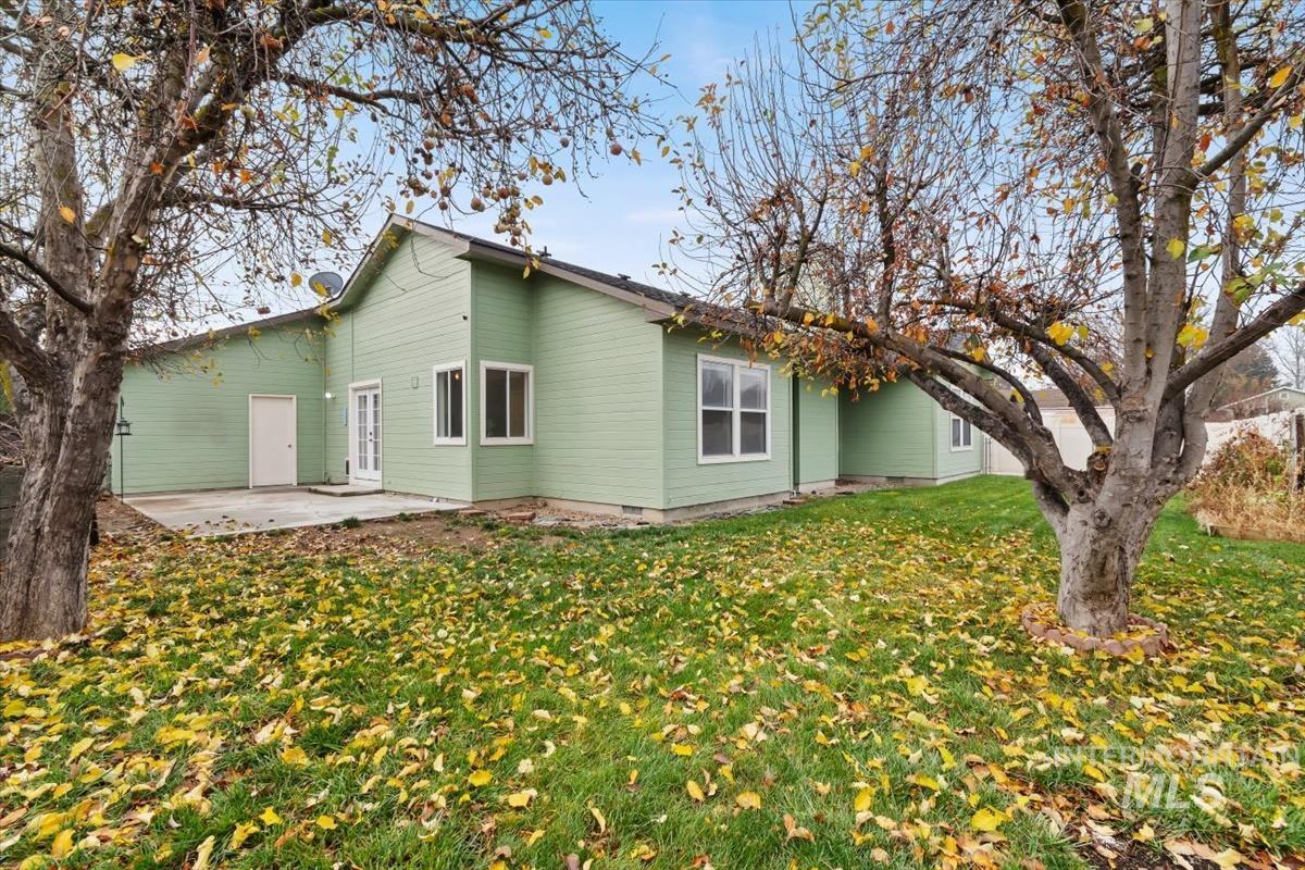 Rear view of house with a yard, a patio area, and crawl space