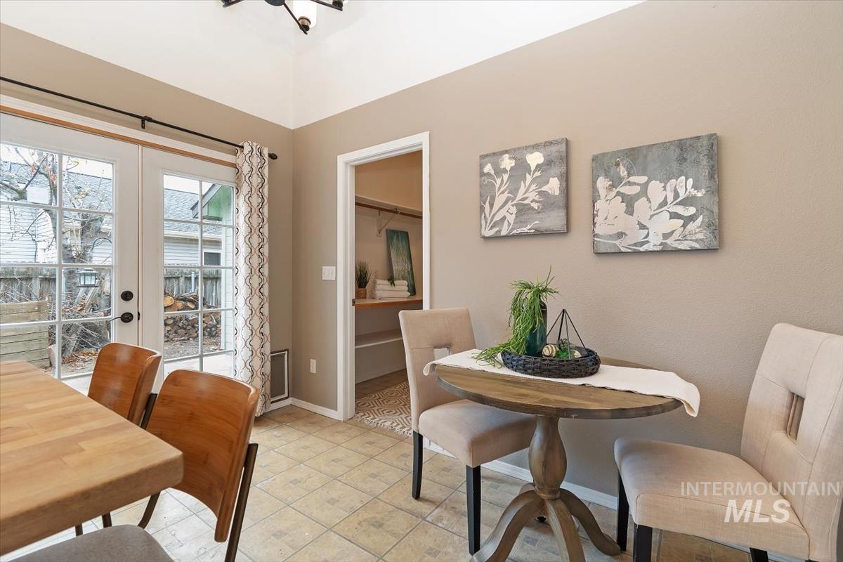 Dining area with french doors and light tile patterned floors