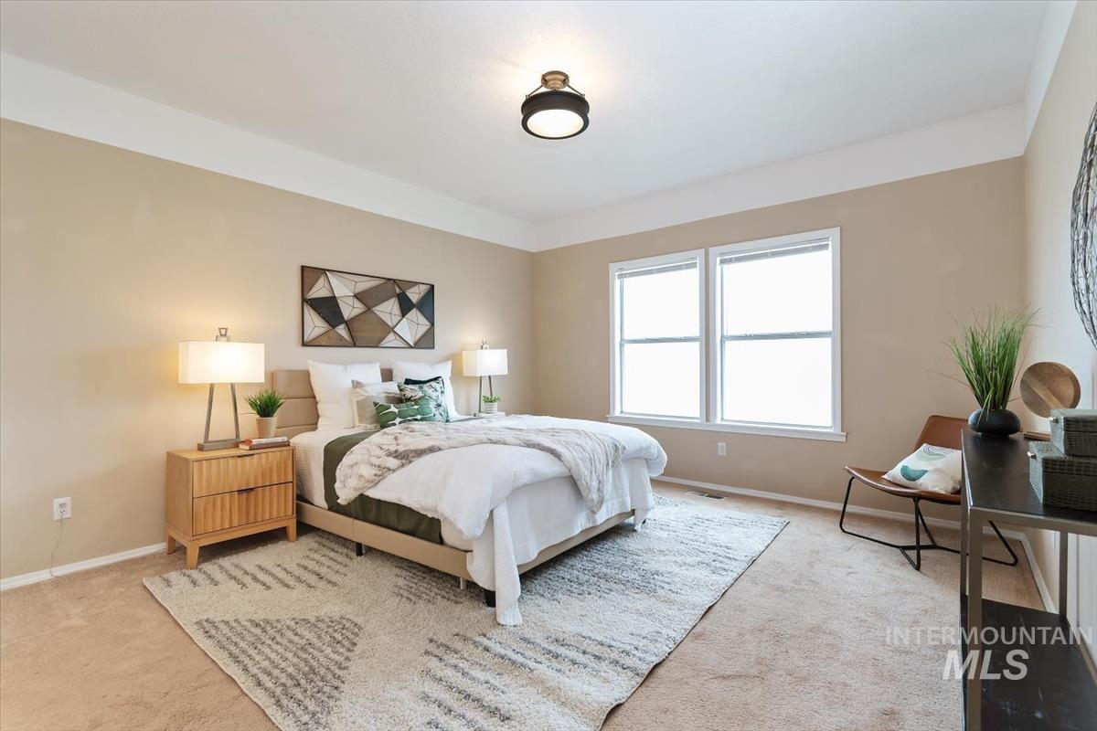 Bedroom with carpet flooring and baseboards