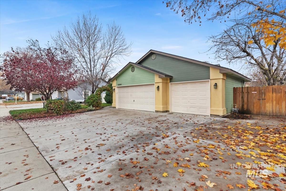 View of home's exterior with concrete driveway and a garage