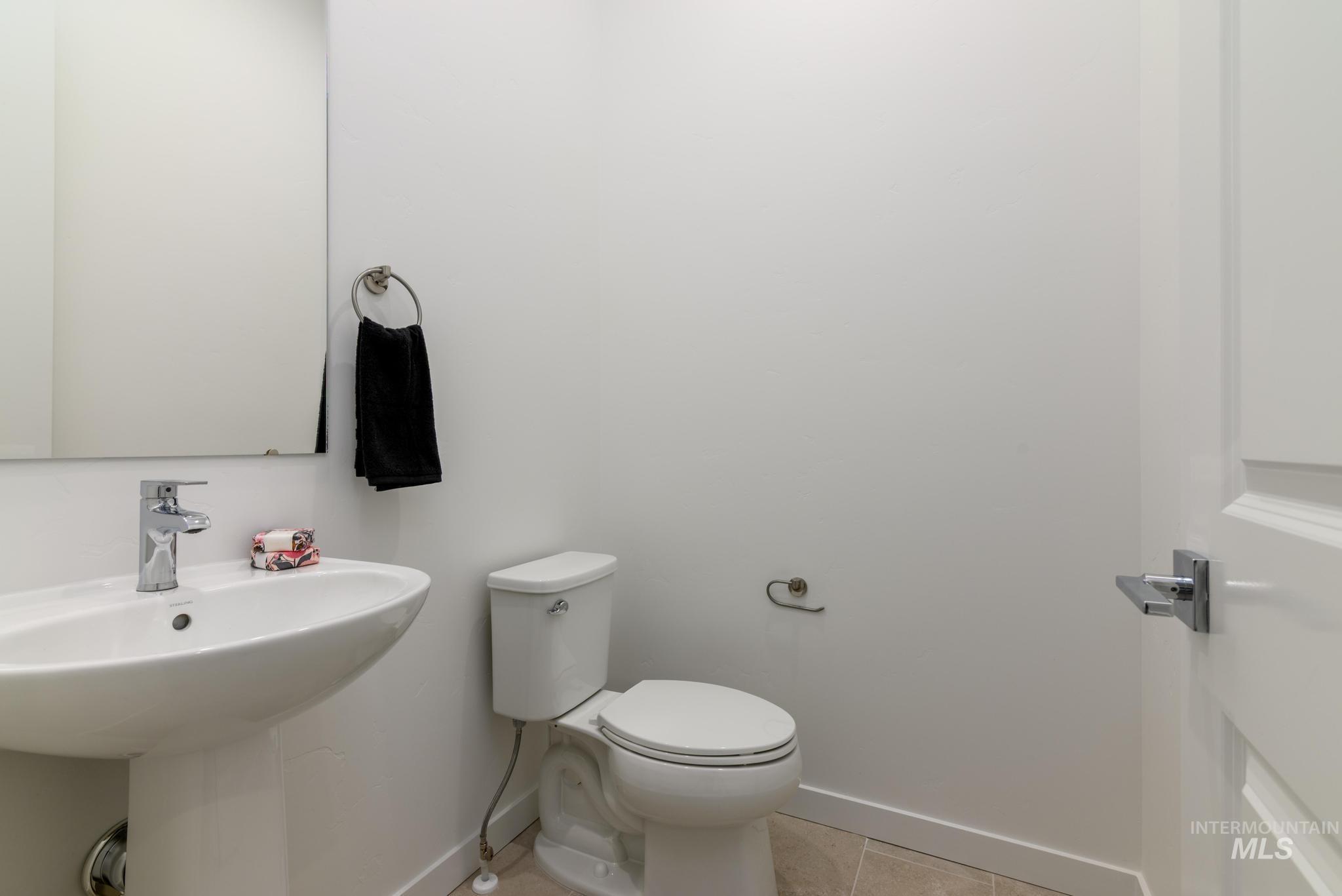 Bathroom with tile patterned floors and toilet