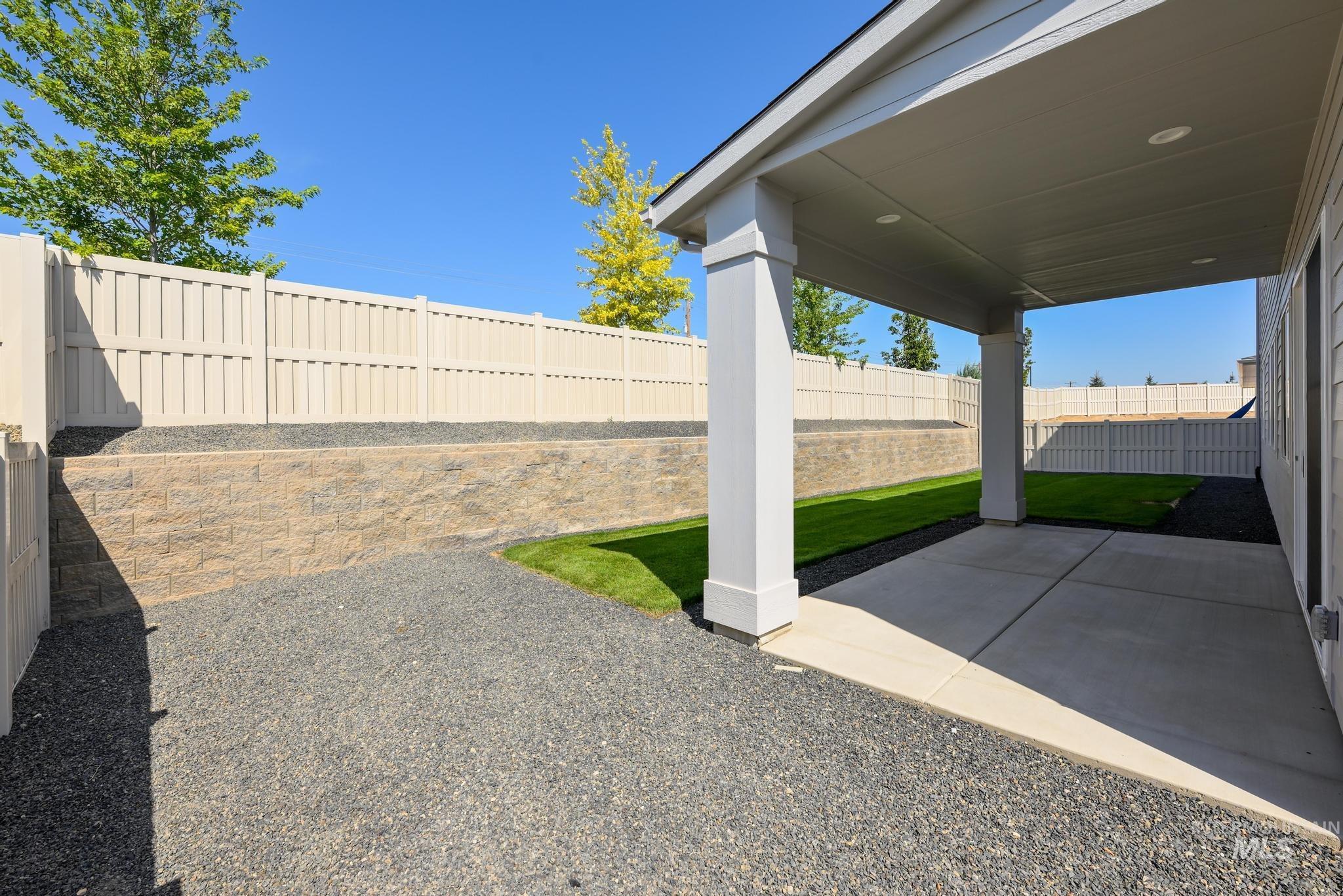 Fenced backyard featuring a patio