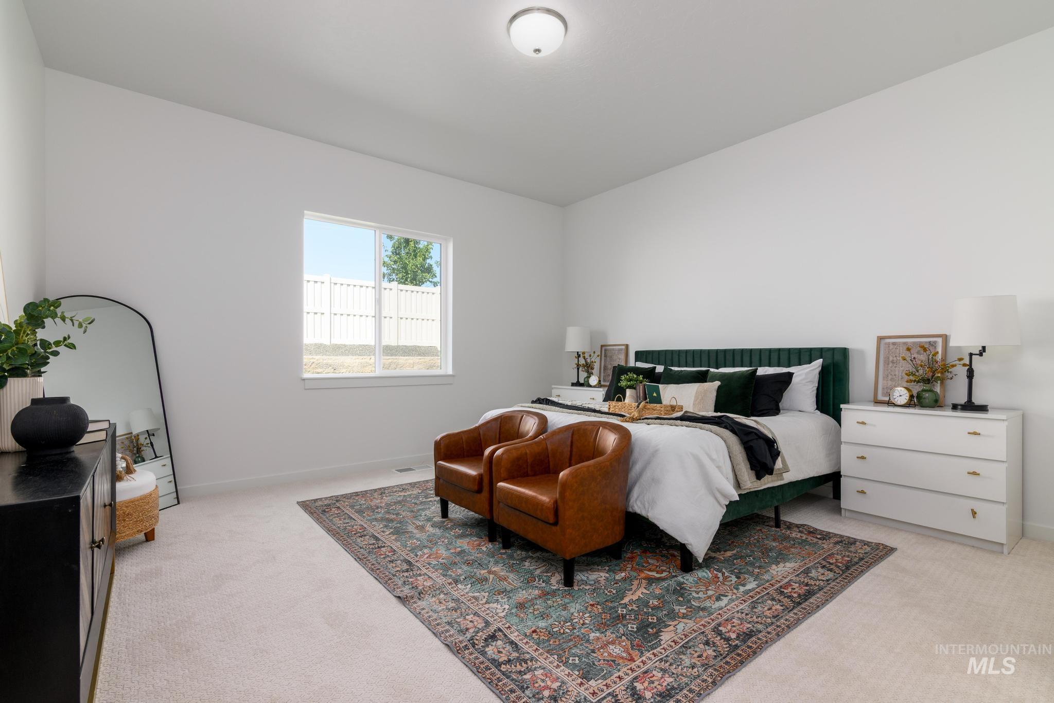 Bedroom with light carpet and baseboards