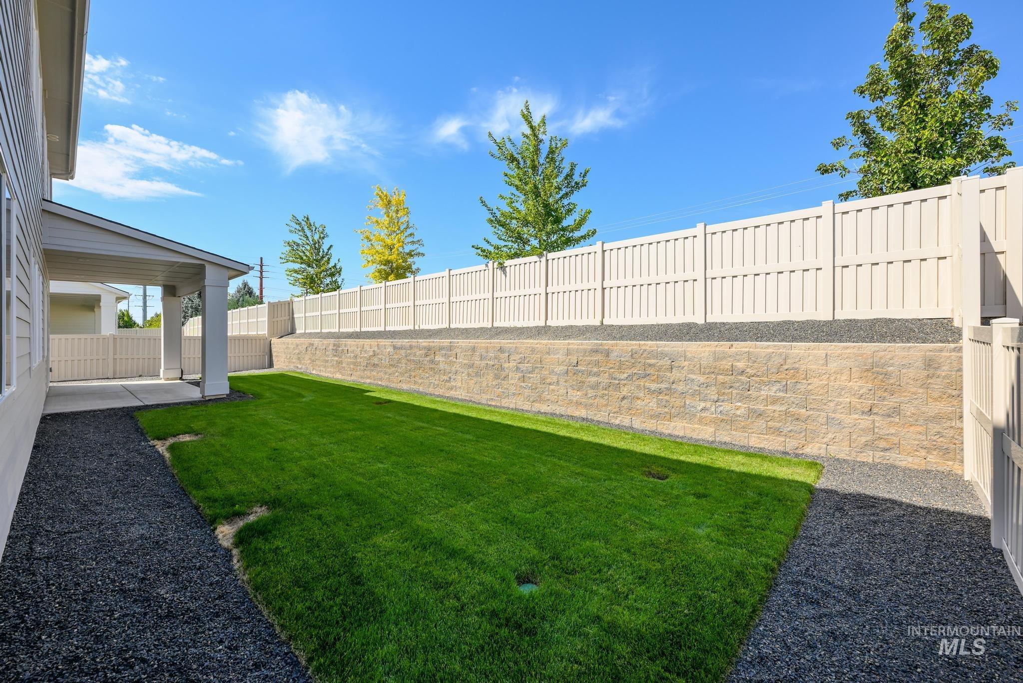Fenced backyard with a patio