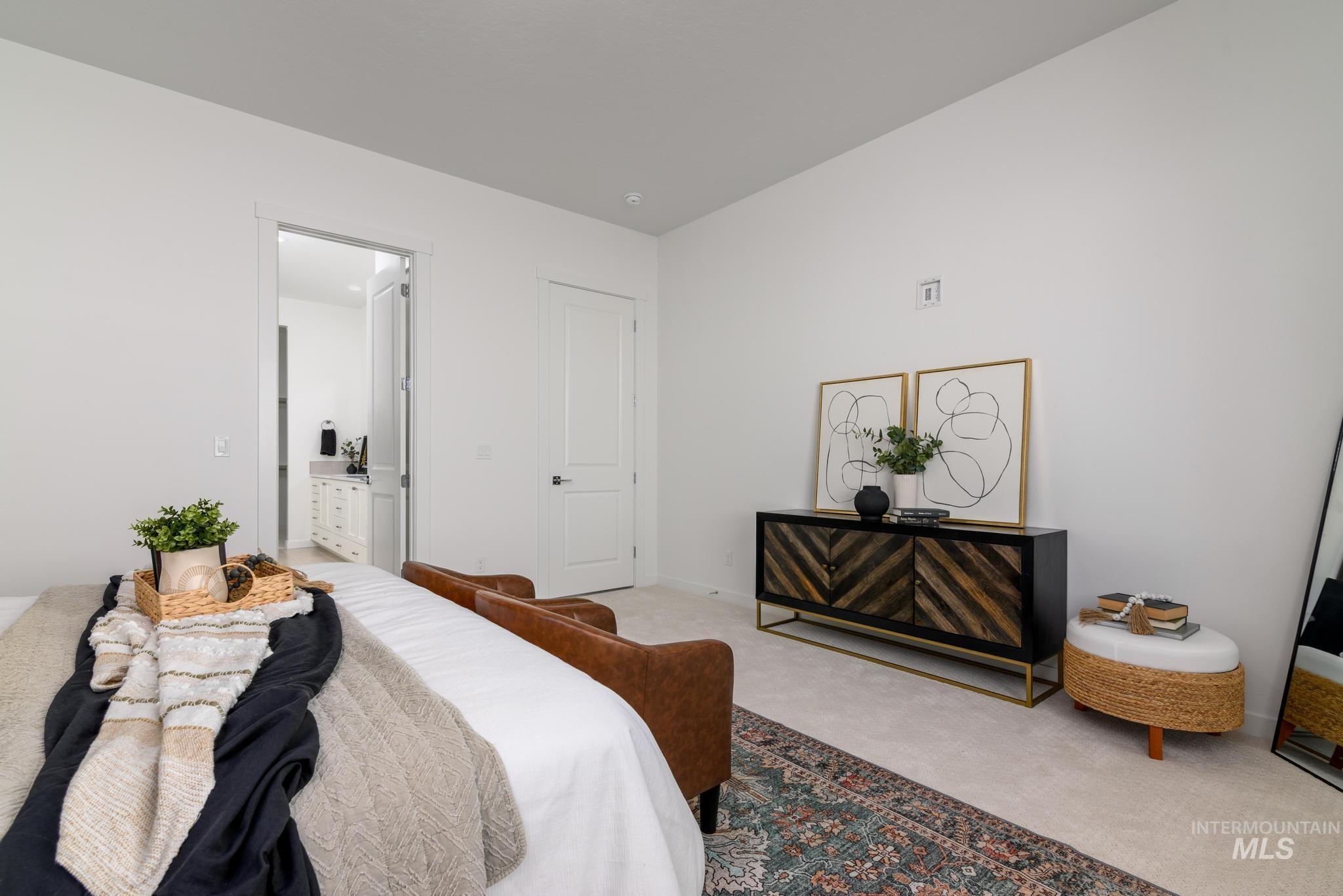 Bedroom featuring carpet and baseboards
