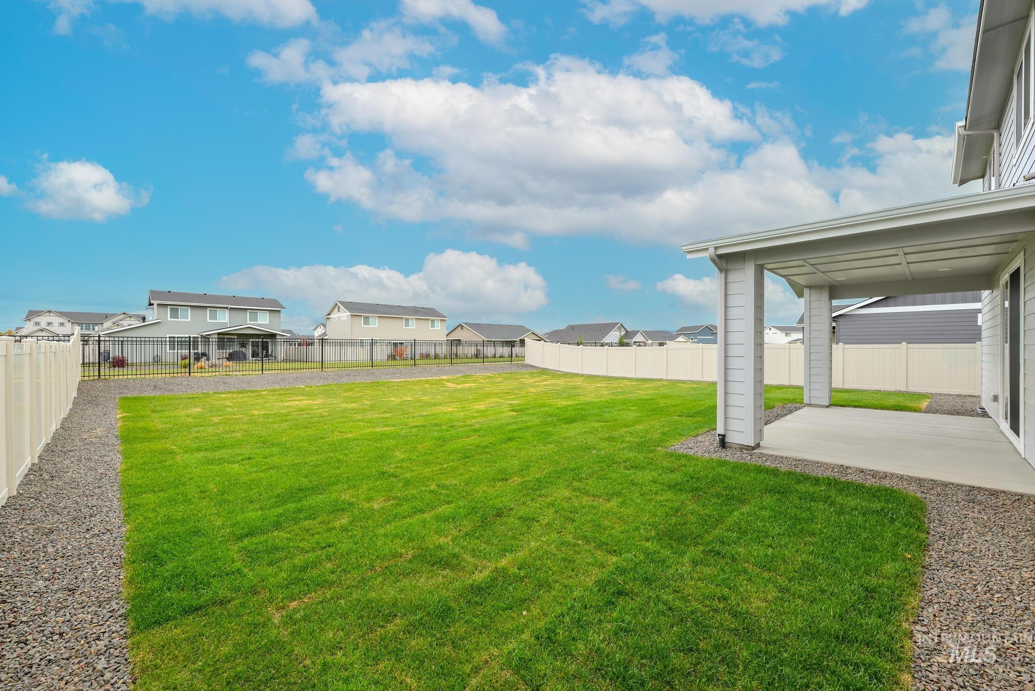 Fenced backyard with a patio and a residential view
