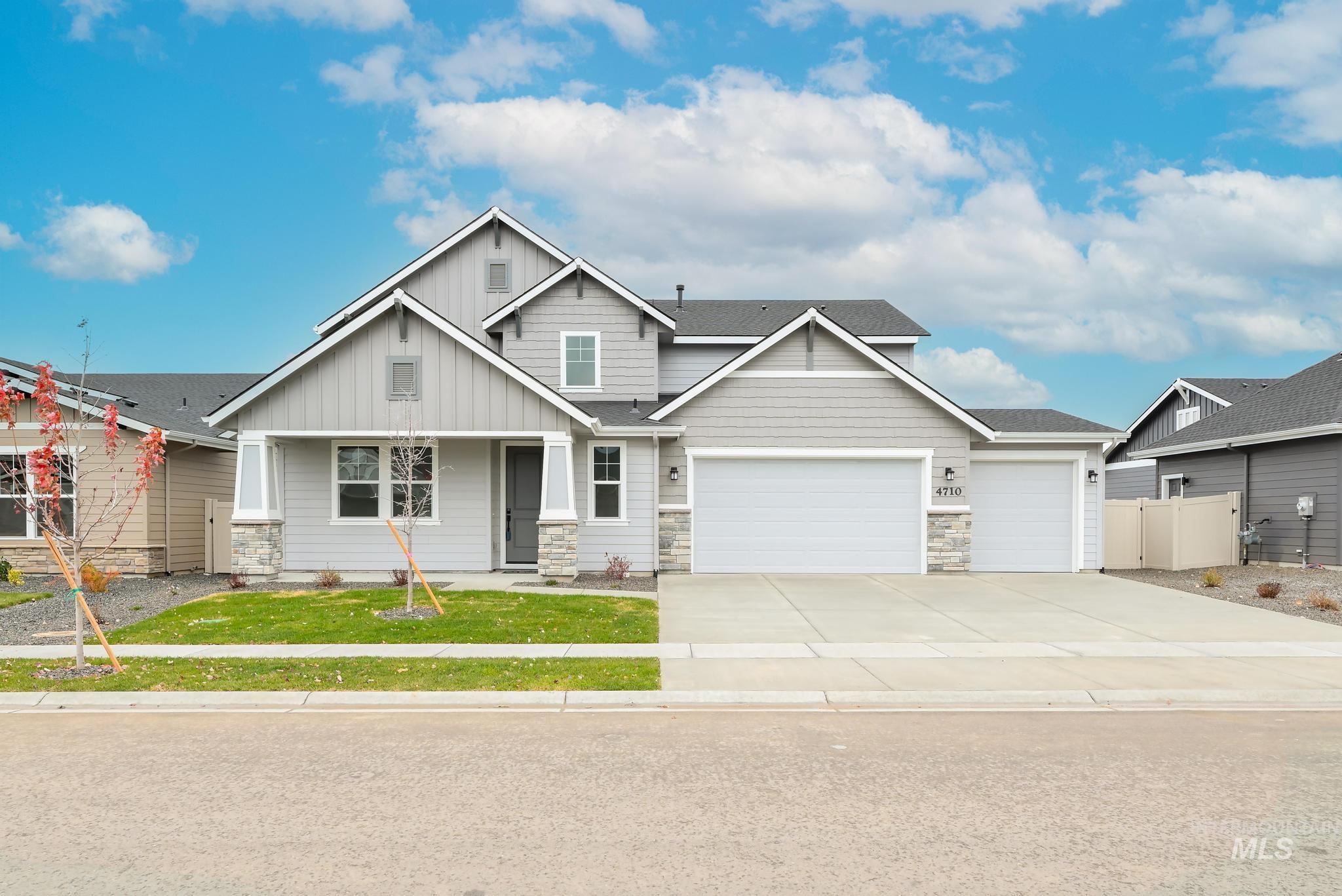 Craftsman inspired home featuring board and batten siding, stone siding, concrete driveway, an attached garage, and a shingled roof