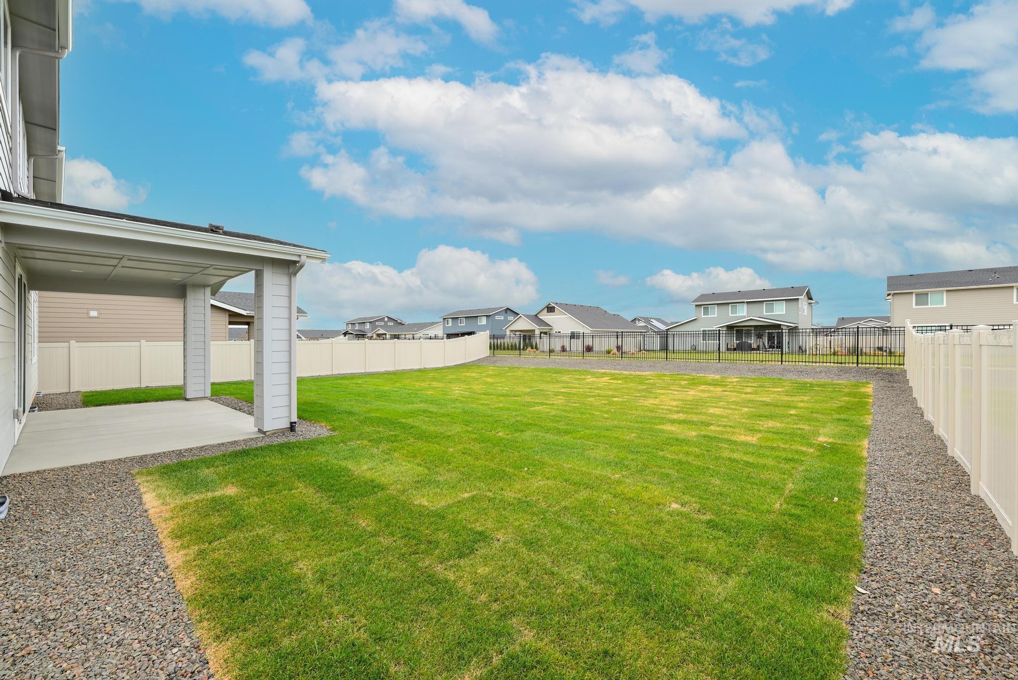 Fenced backyard with a patio and a residential view
