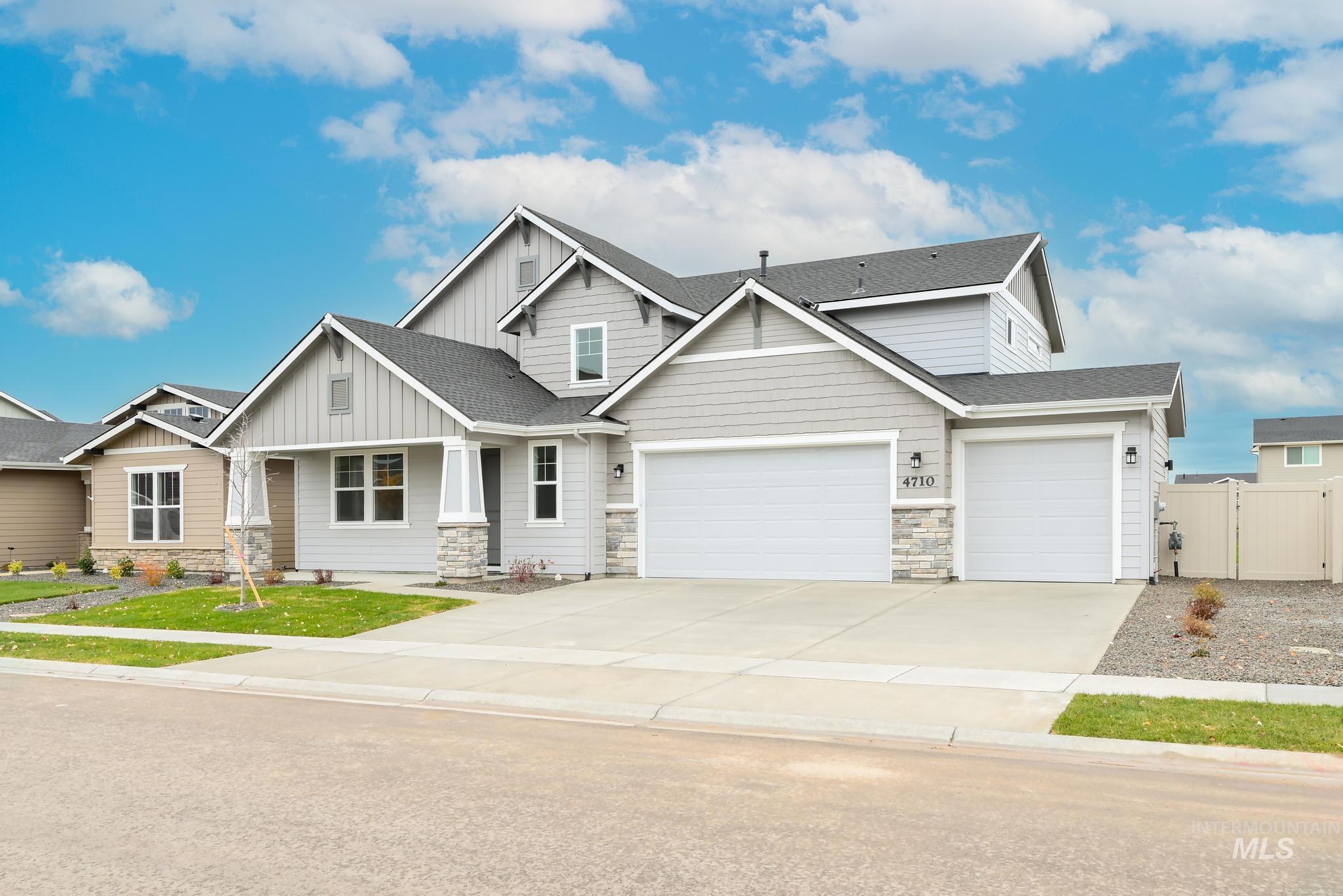 Craftsman house featuring stone siding, covered porch, driveway, and a shingled roof