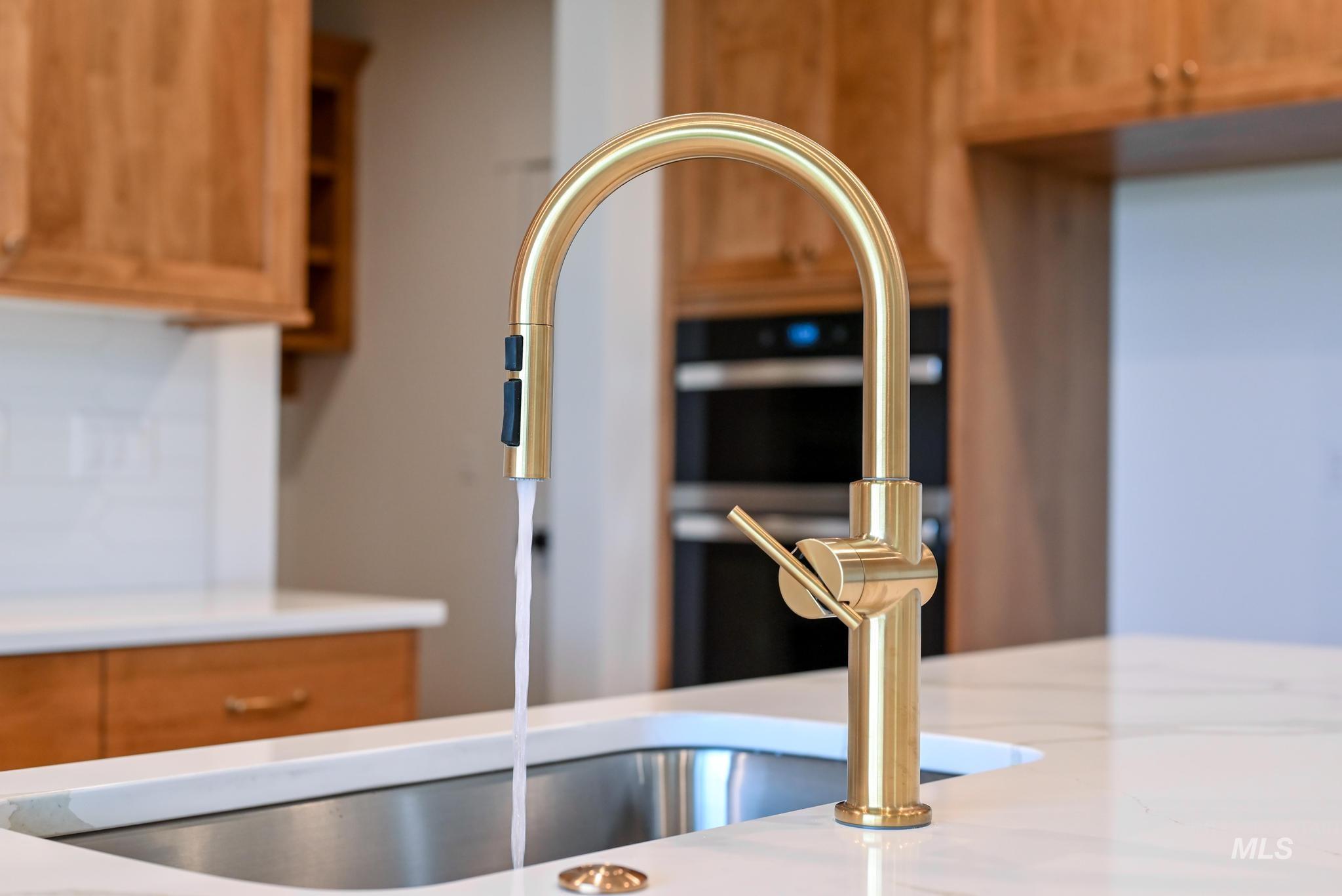 Kitchen view of a sink and brown cabinets